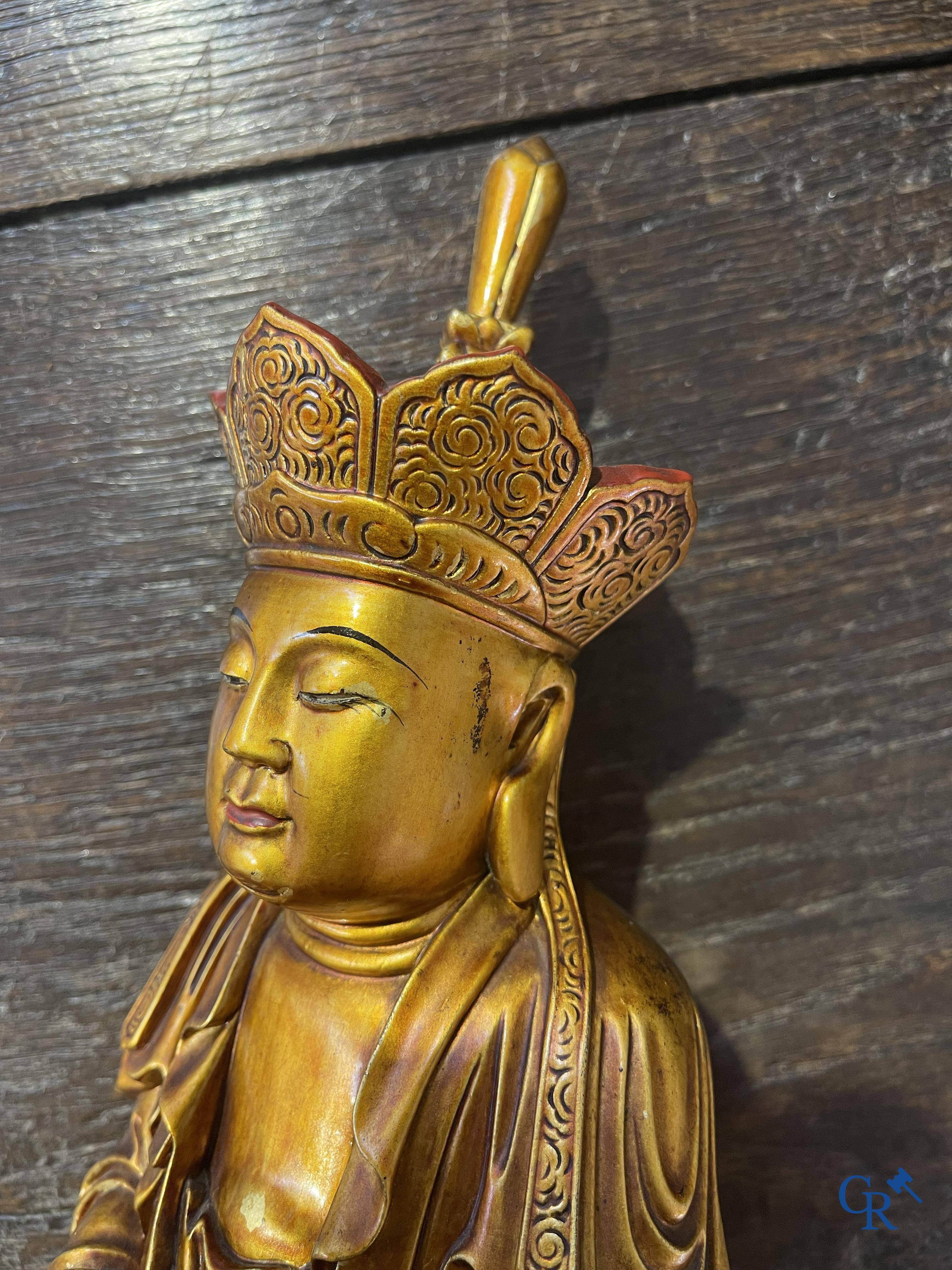 Asian Art: A Chinese sculpture of Vaishravana on a Buddhist lion in lacquered and gilded wood. 19th century.