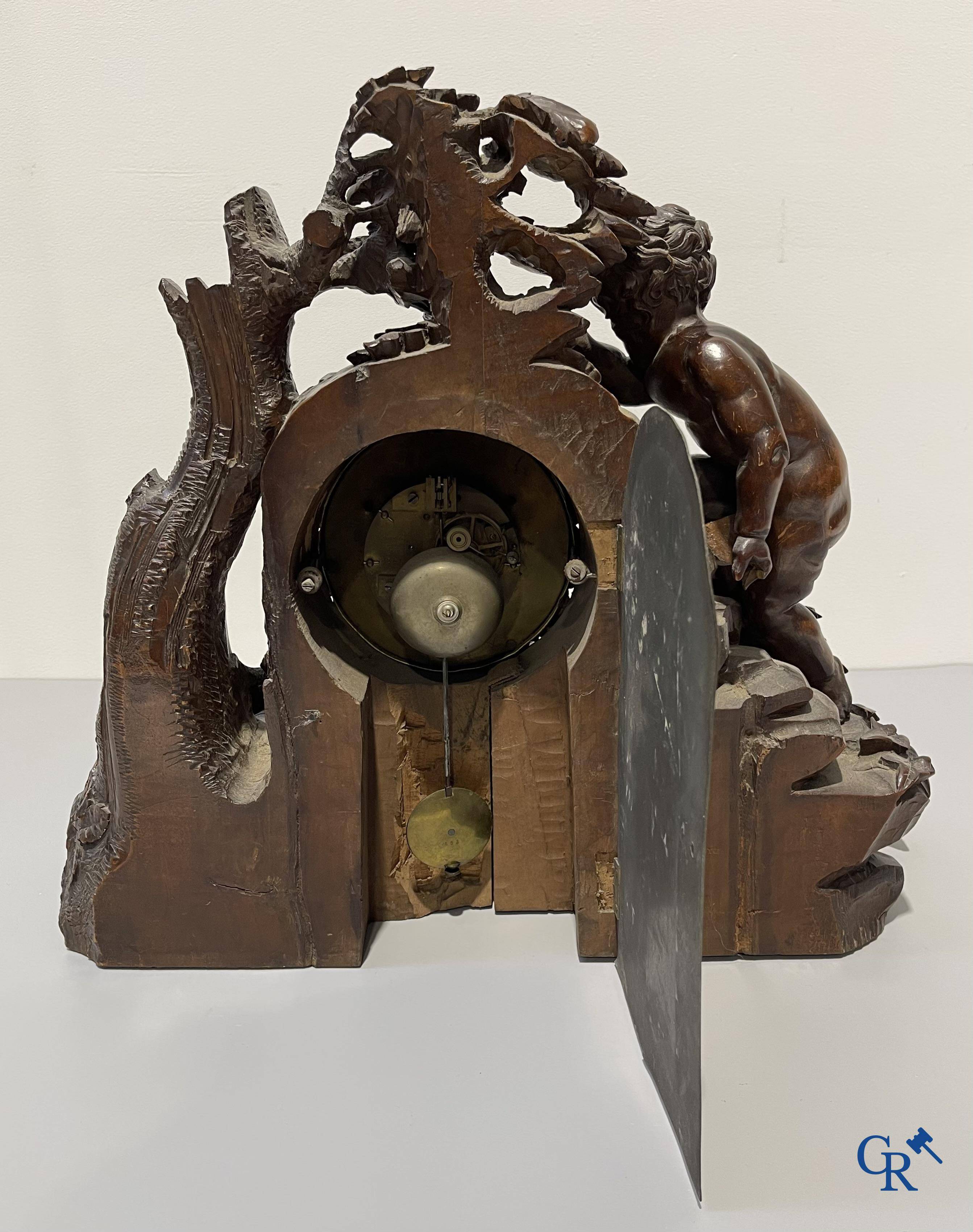 A finely carved walnut clock in so-called "black forest" carving. French work circa 1860-1880.