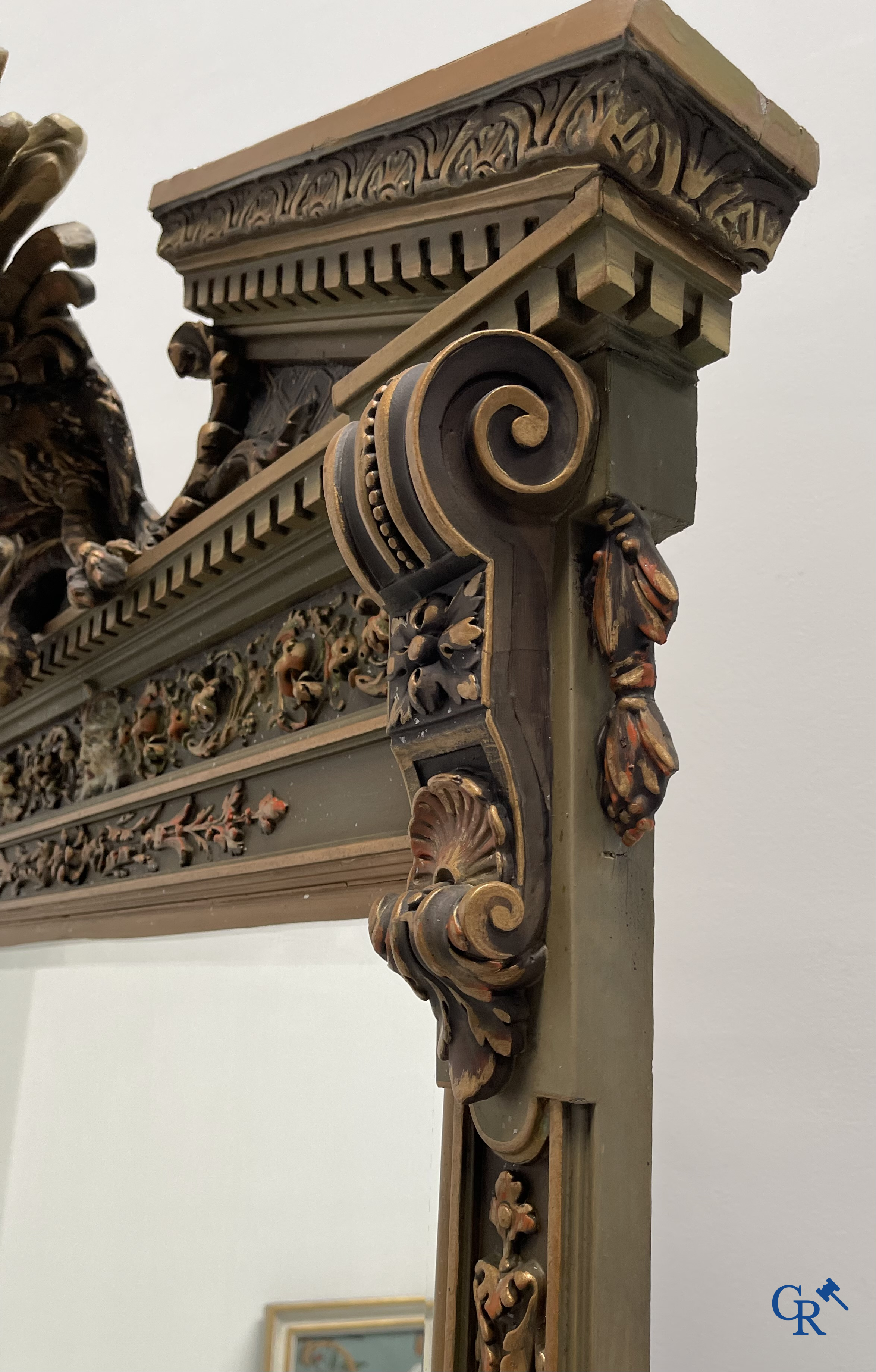 A large patinated fireplace mirror with a dragon. Around 1900.