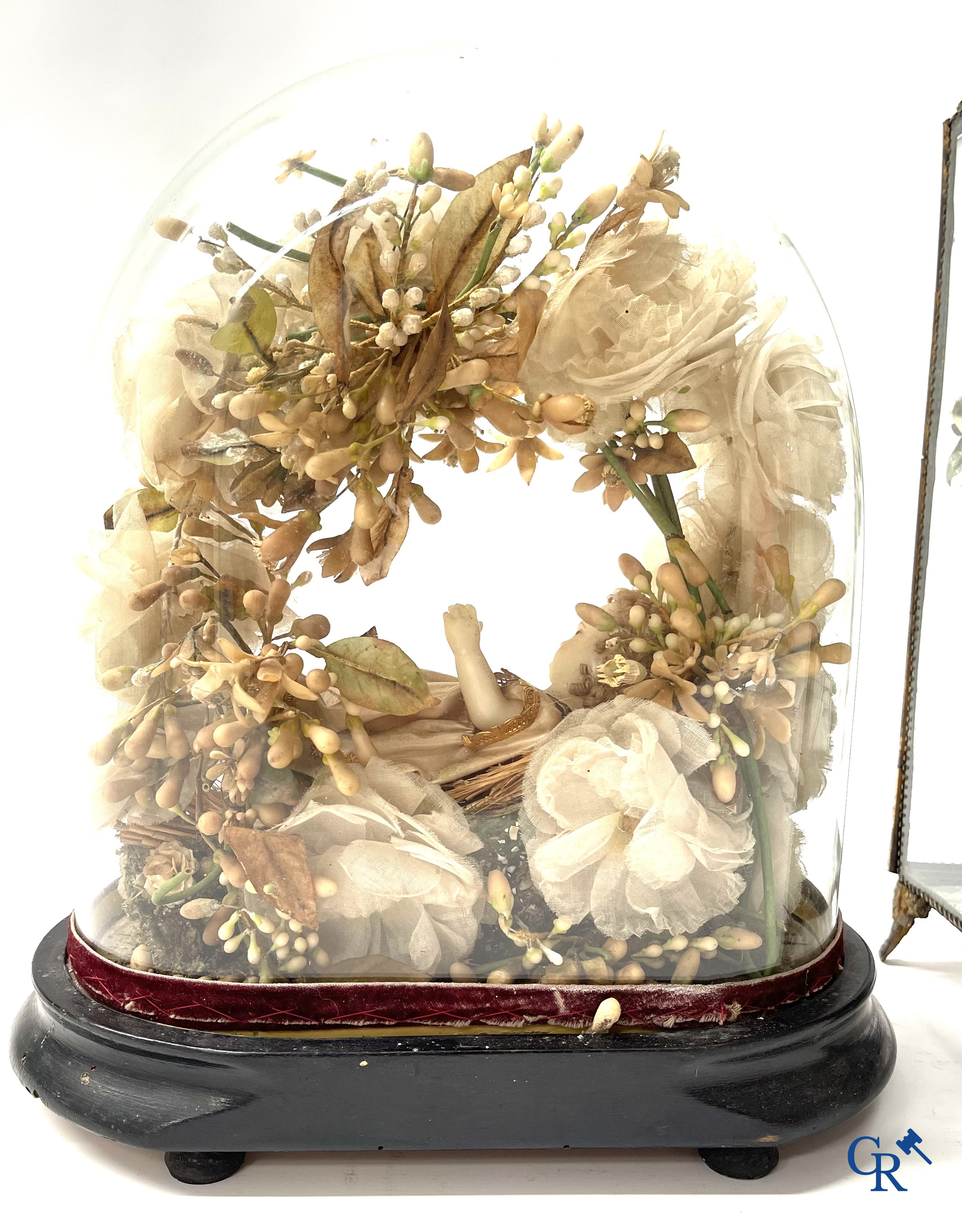 A globe in glass with a child in wax and a brass display case with bridal bouquet. Around 1900.