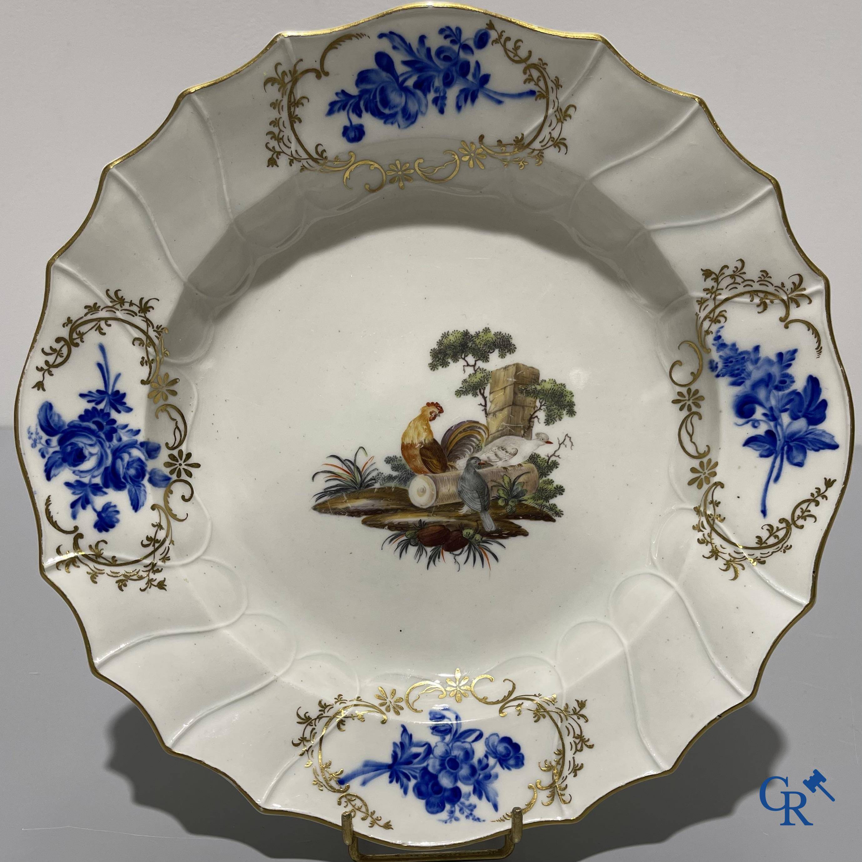 European porcelain, Tournai. 2 plates with a polychrome decoration of birds and gold decoration in The Hague. 18th century.