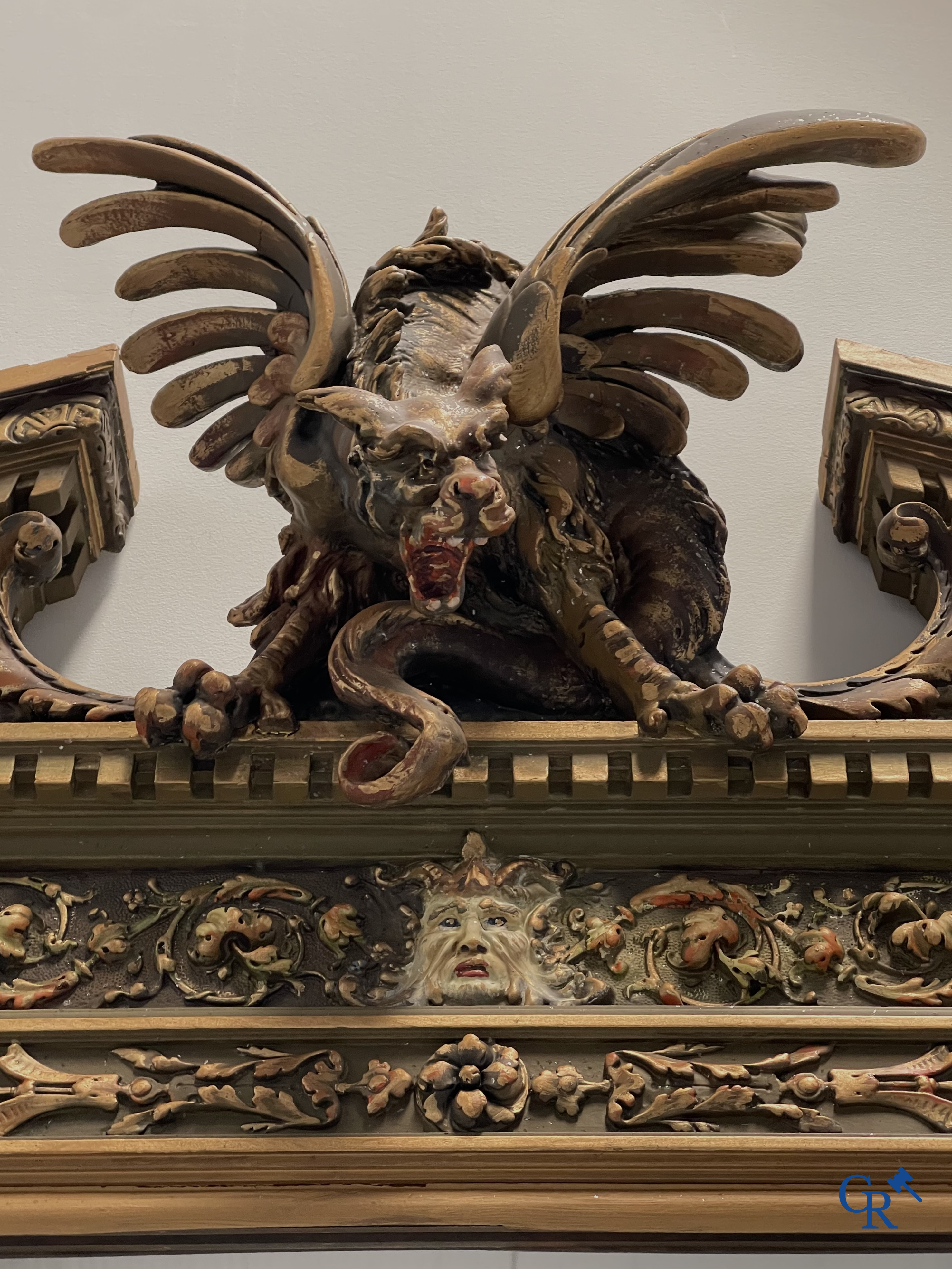 A large patinated fireplace mirror with a dragon. Around 1900.