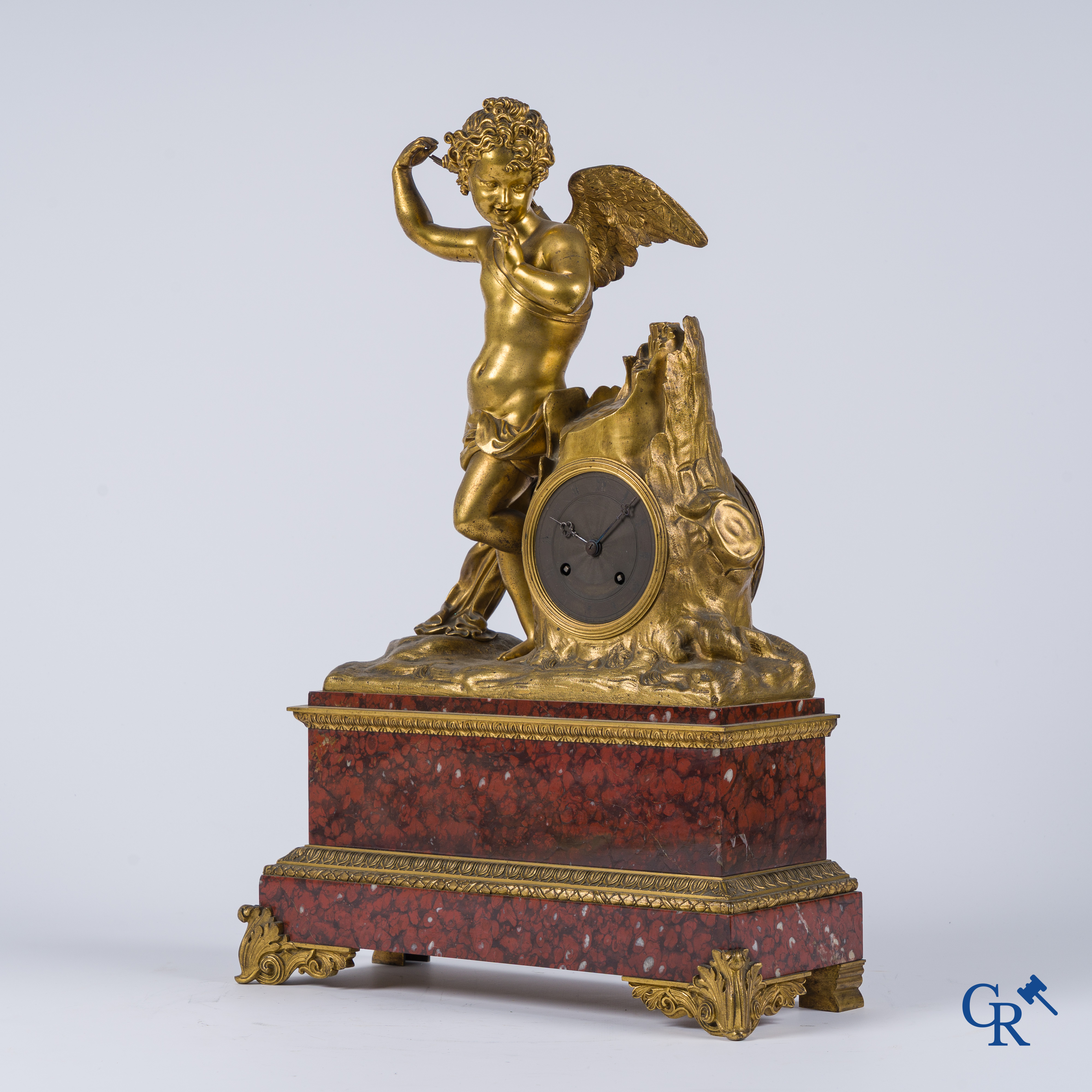 Charles X, a pendulum with finely chiseled cupid in gilded bronze. Red veined marble pedestal, circa 1840.
