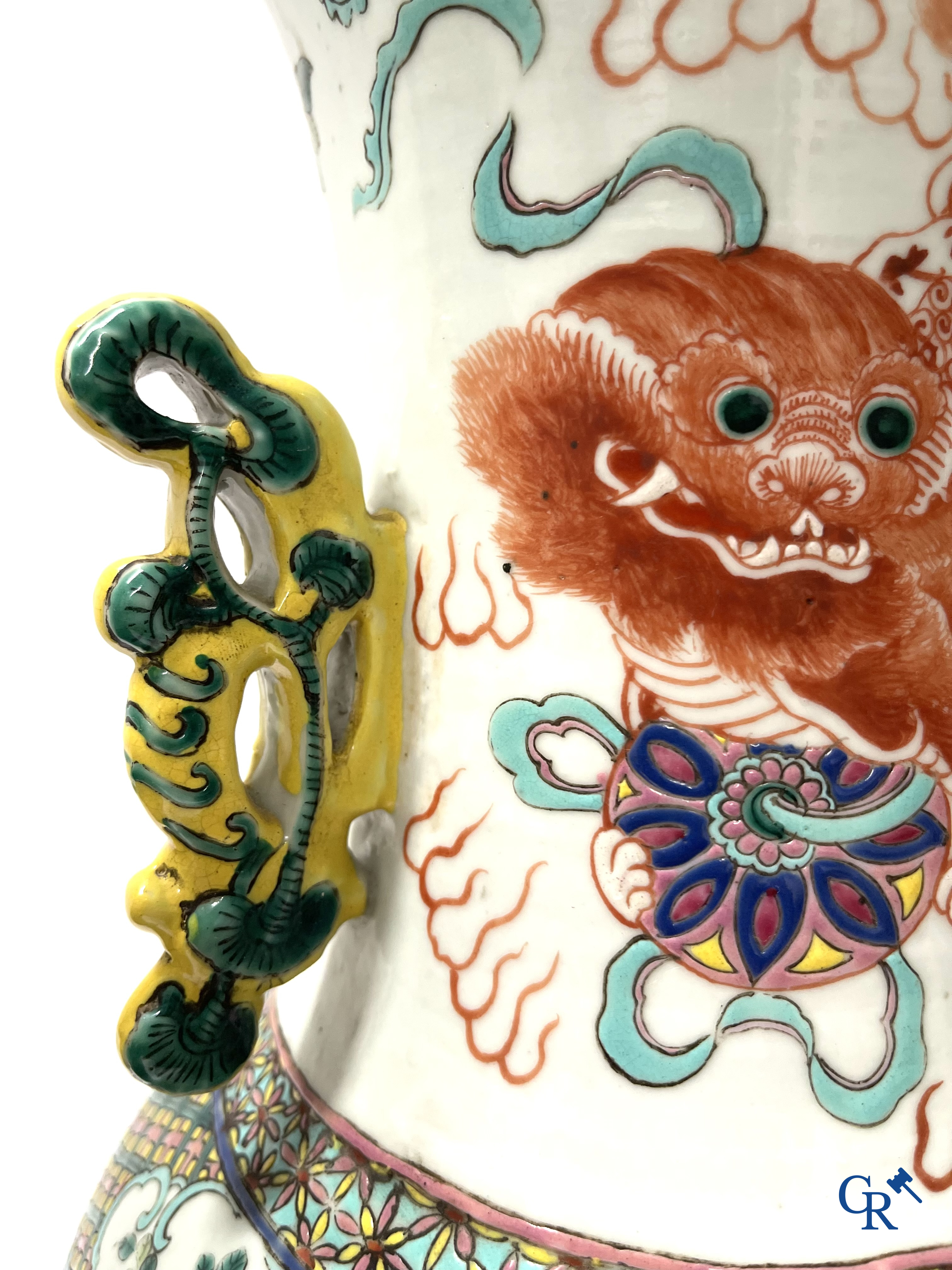 Asian Art, A pair of Chinese famille rose vases with peacocks and Fo dogs. 19th century.