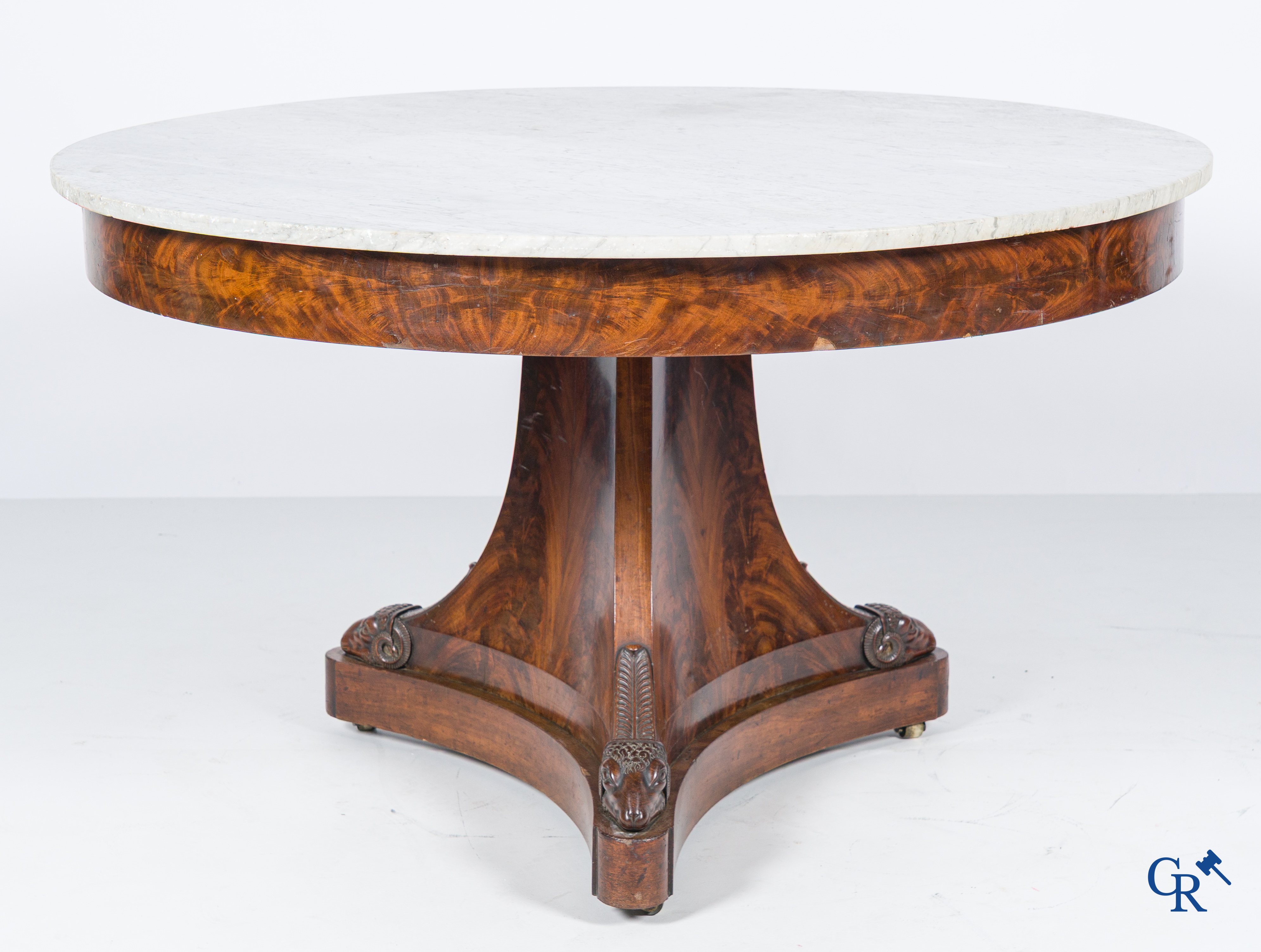 Large round three-legged table with ram heads in mahogany and white marble top. Empire period. 1st quarter 19th century.