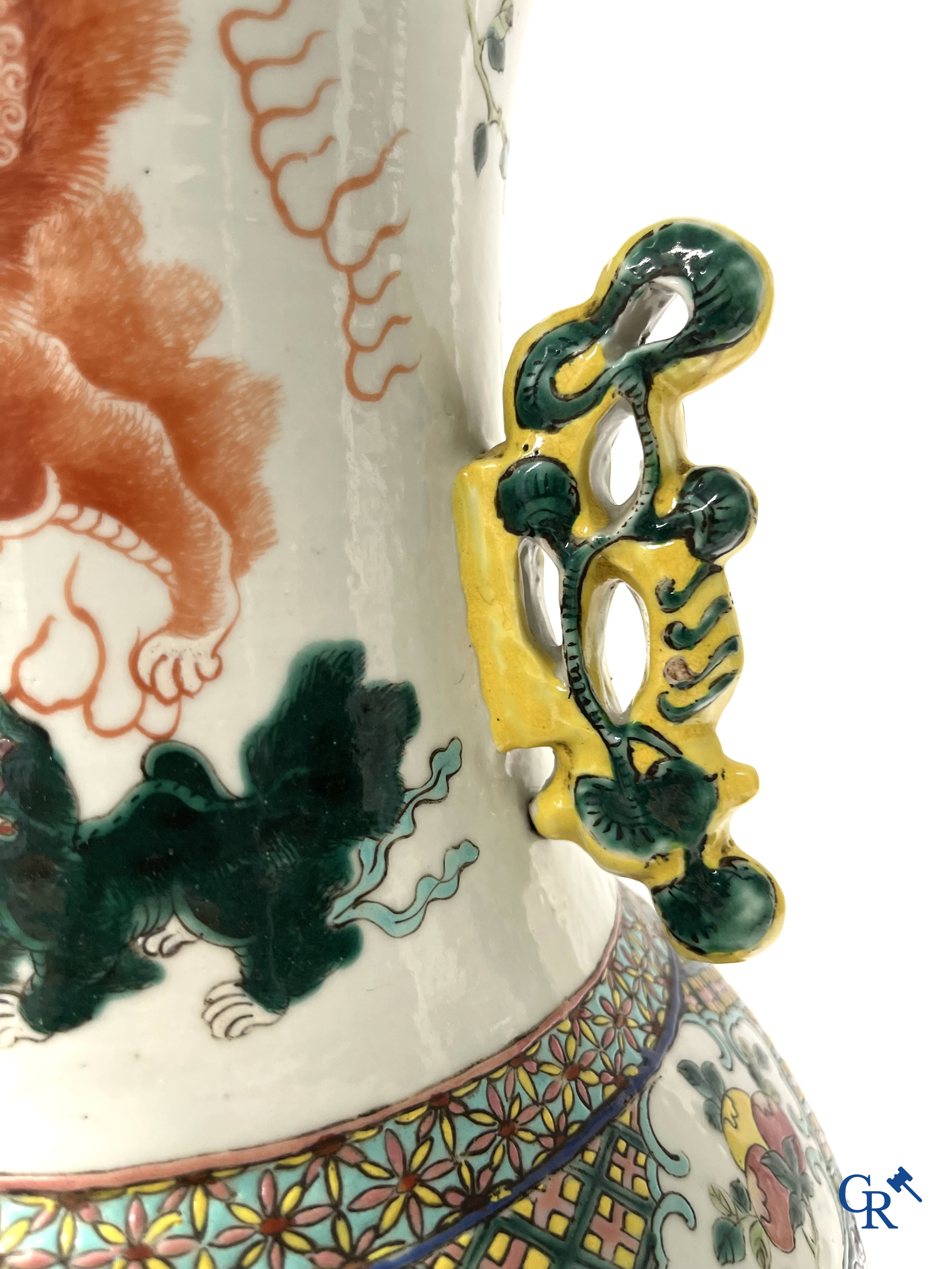 Asian Art, A pair of Chinese famille rose vases with peacocks and Fo dogs. 19th century.
