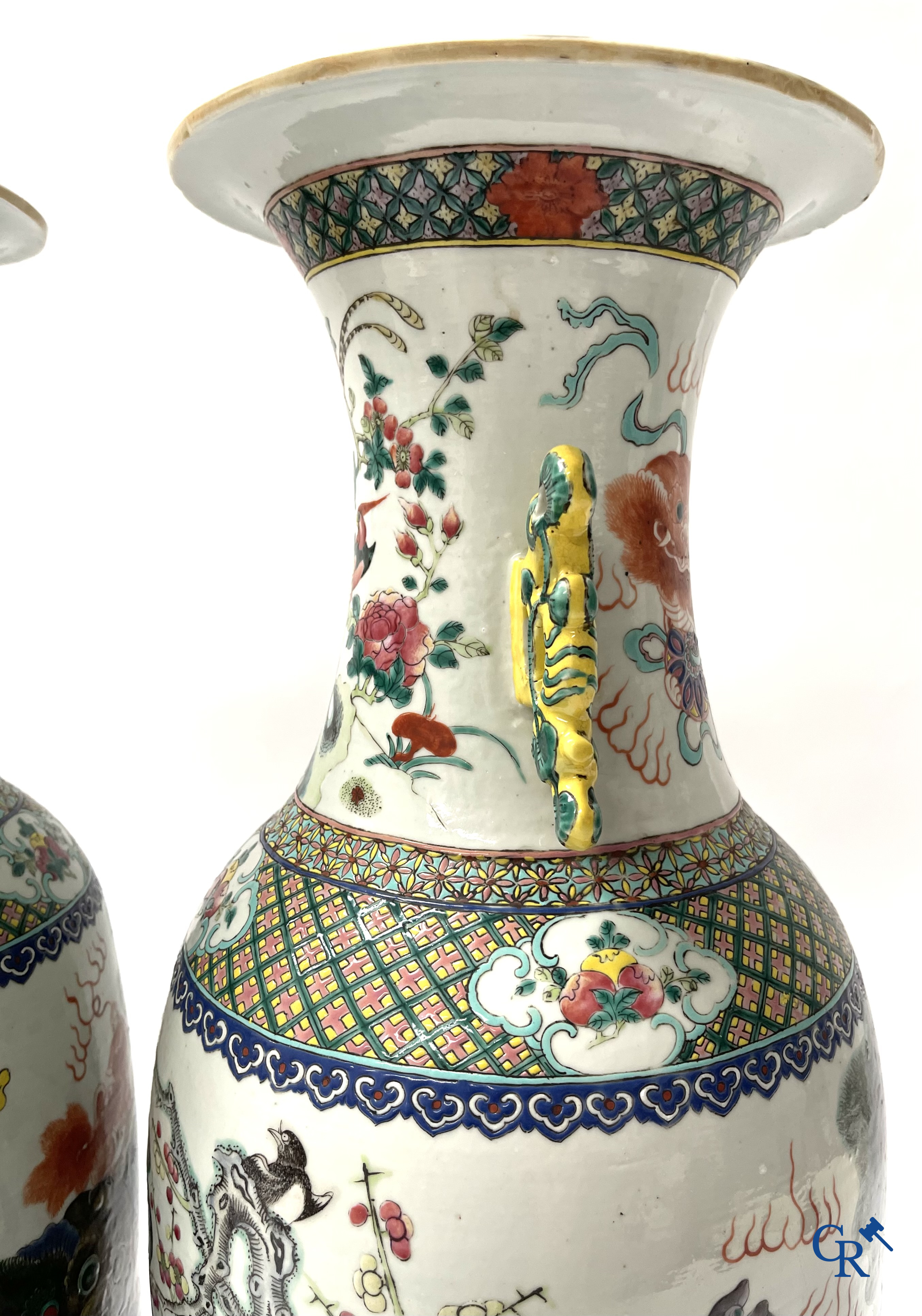 Asian Art, A pair of Chinese famille rose vases with peacocks and Fo dogs. 19th century.