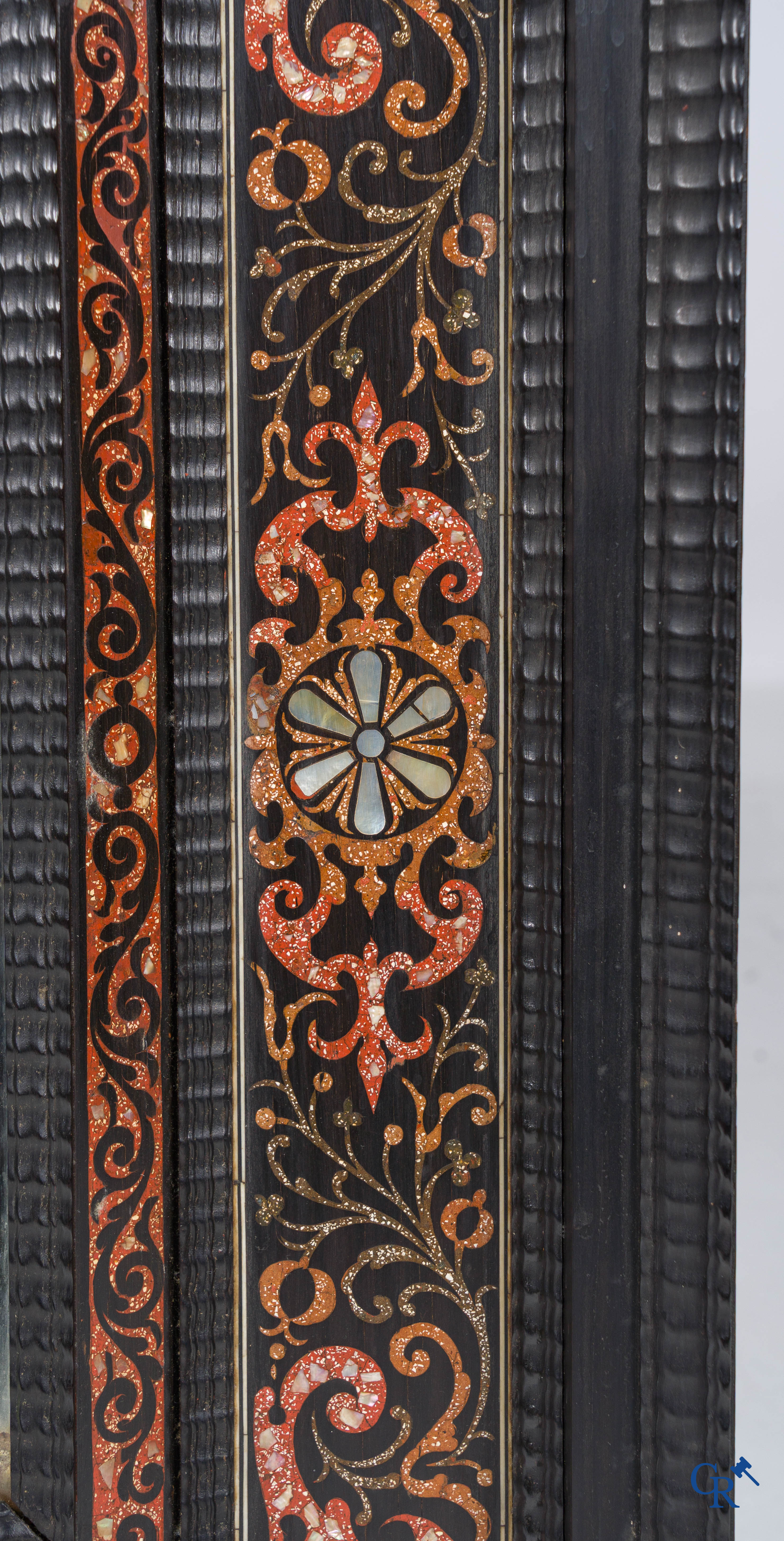 A mirror in ebony and inlay. 18th- 19th century.