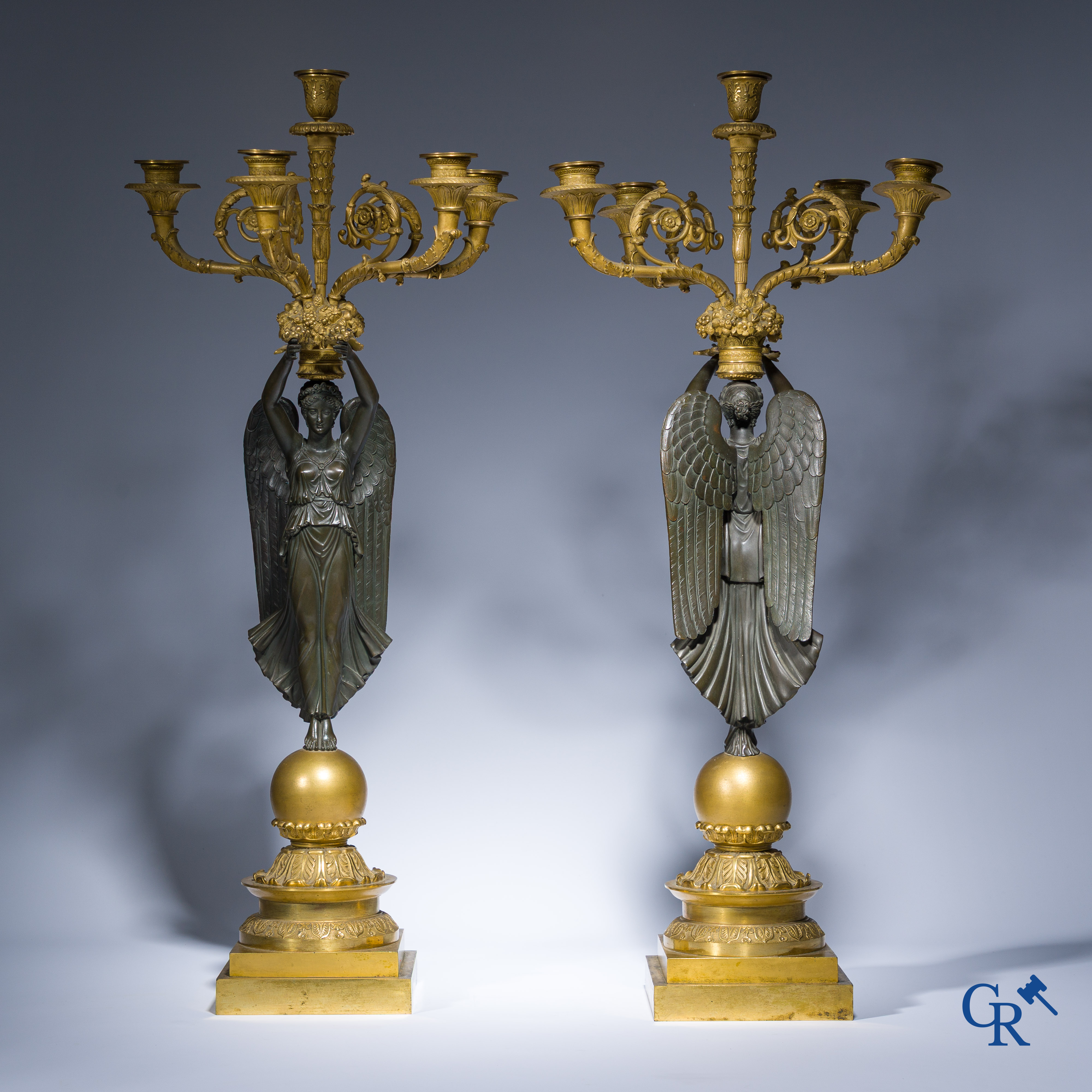 Empire, A pair of large gilded and patinated bronze candlesticks with winged women, circa 1810.