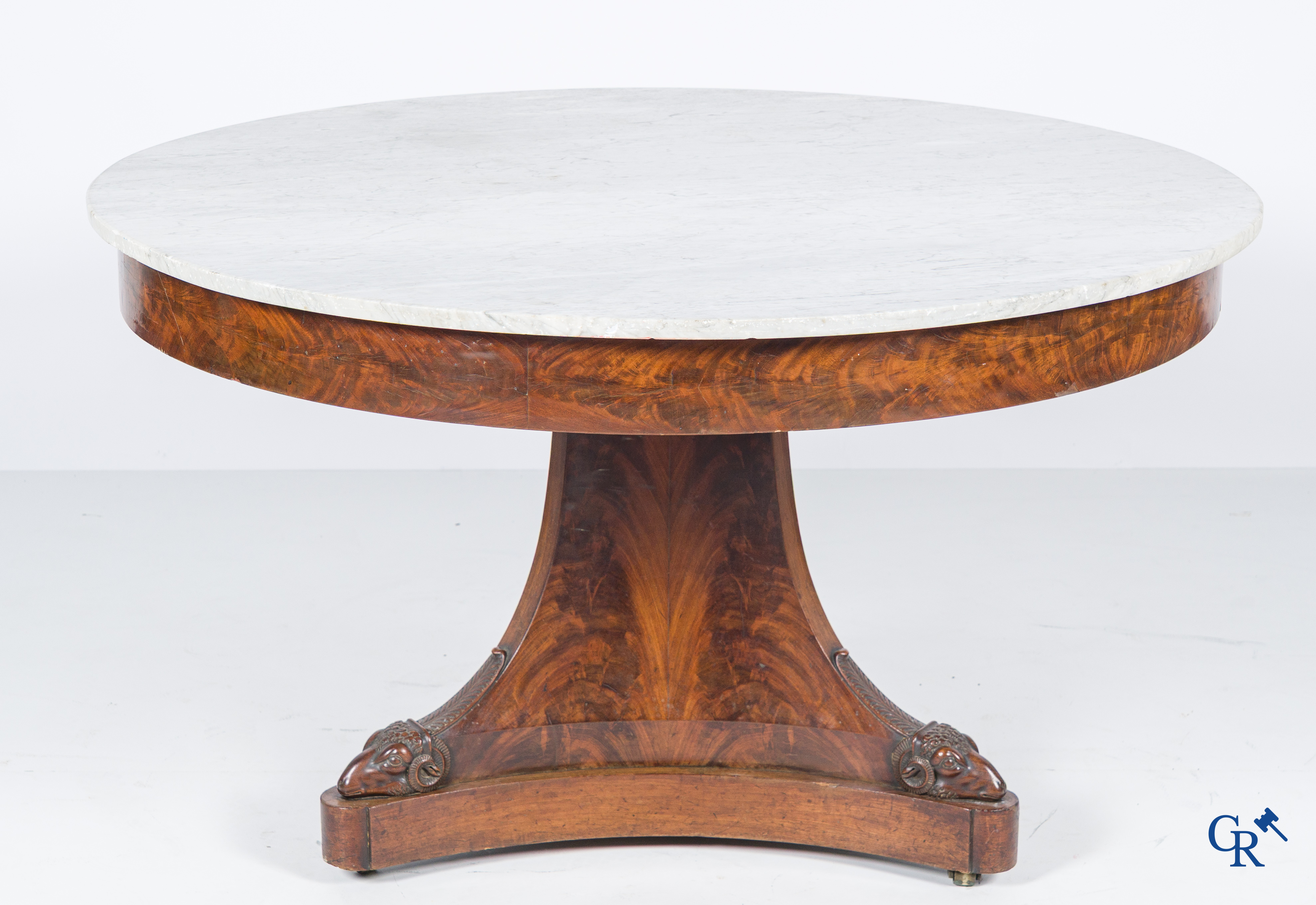Large round three-legged table with ram heads in mahogany and white marble top. Empire period. 1st quarter 19th century.