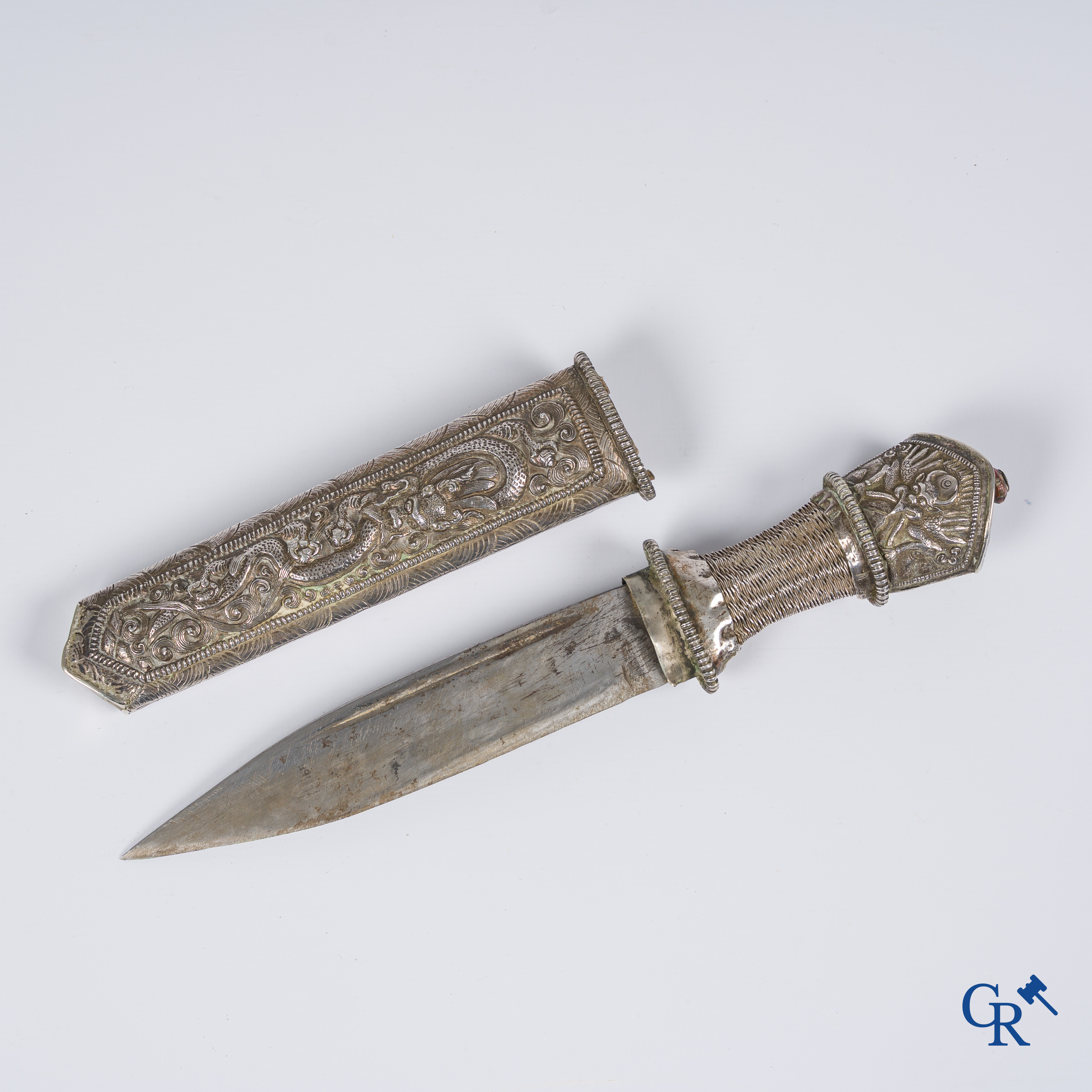 Asian Art, a richly carved silver Tibetan dagger with dragon motif. 19th century.