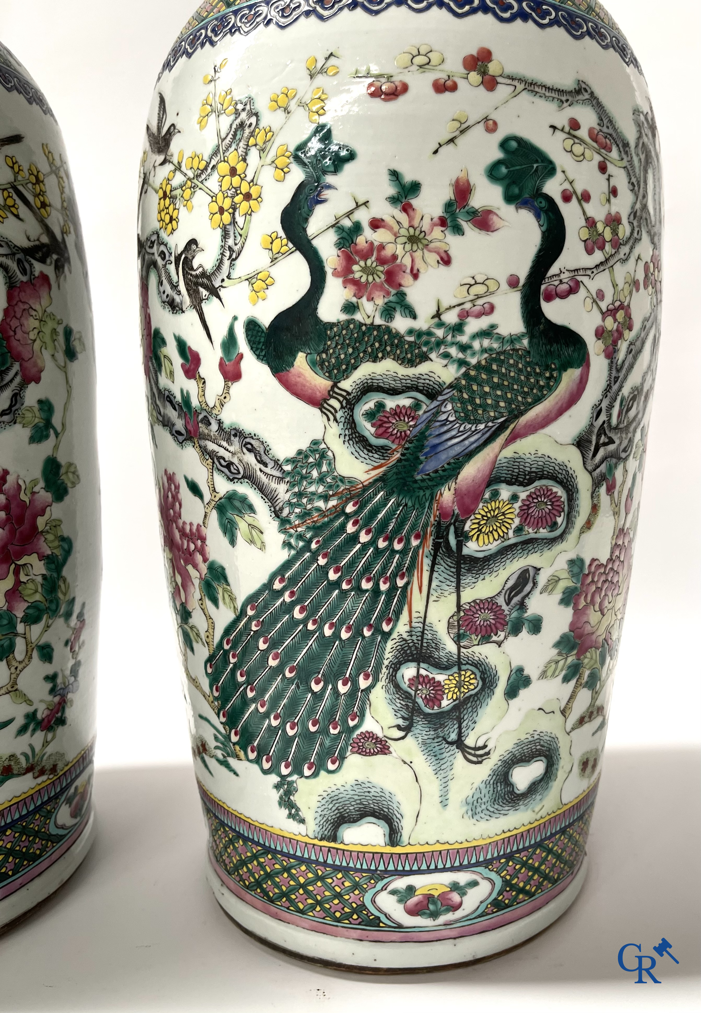 Asian Art, A pair of Chinese famille rose vases with peacocks and Fo dogs. 19th century.