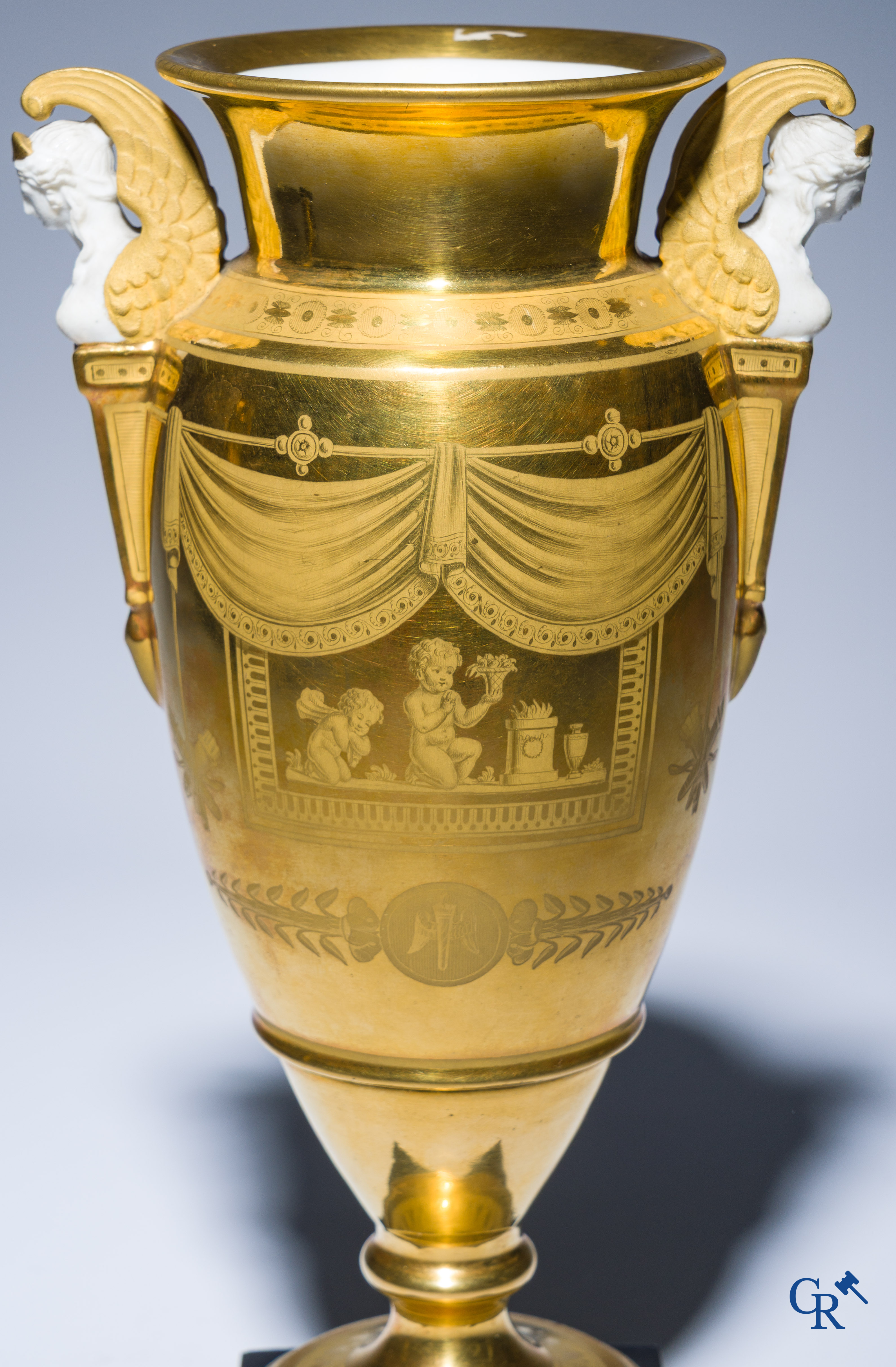 Empire, a pair of finely gilded and decorated vases in porcelain and biscuit on a marble pedestal, Circa 1810.
