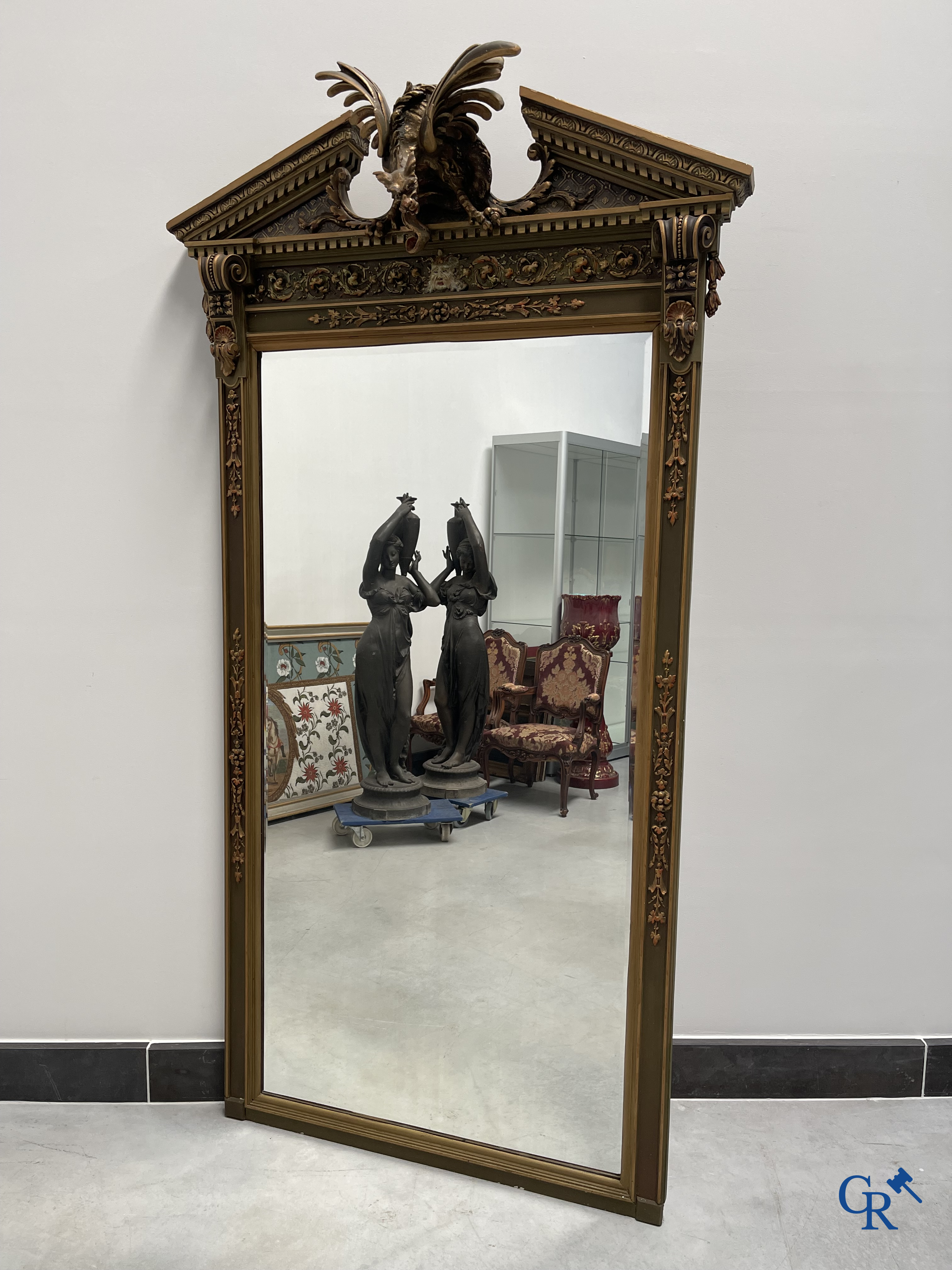 A large patinated fireplace mirror with a dragon. Around 1900.