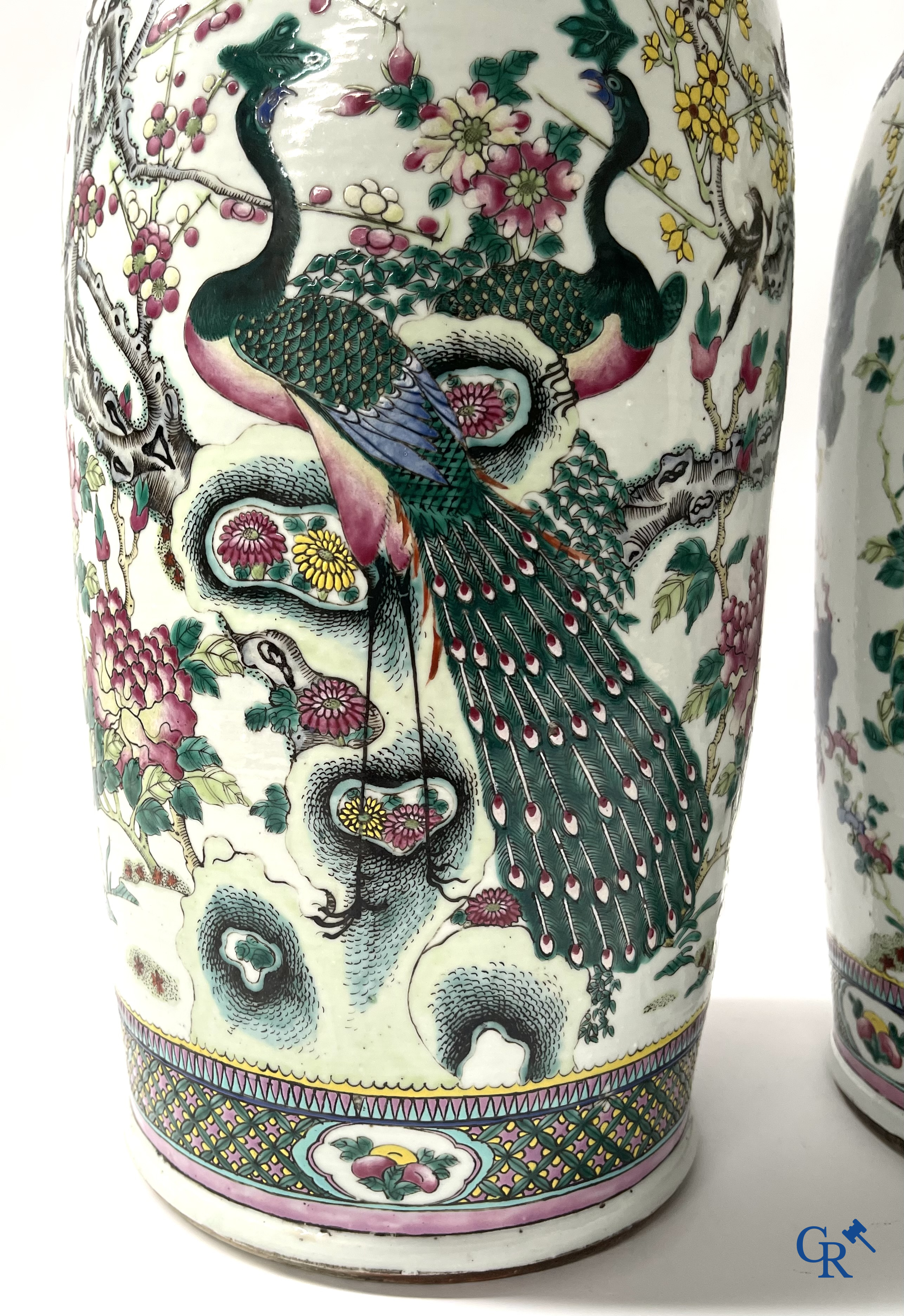 Asian Art, A pair of Chinese famille rose vases with peacocks and Fo dogs. 19th century.