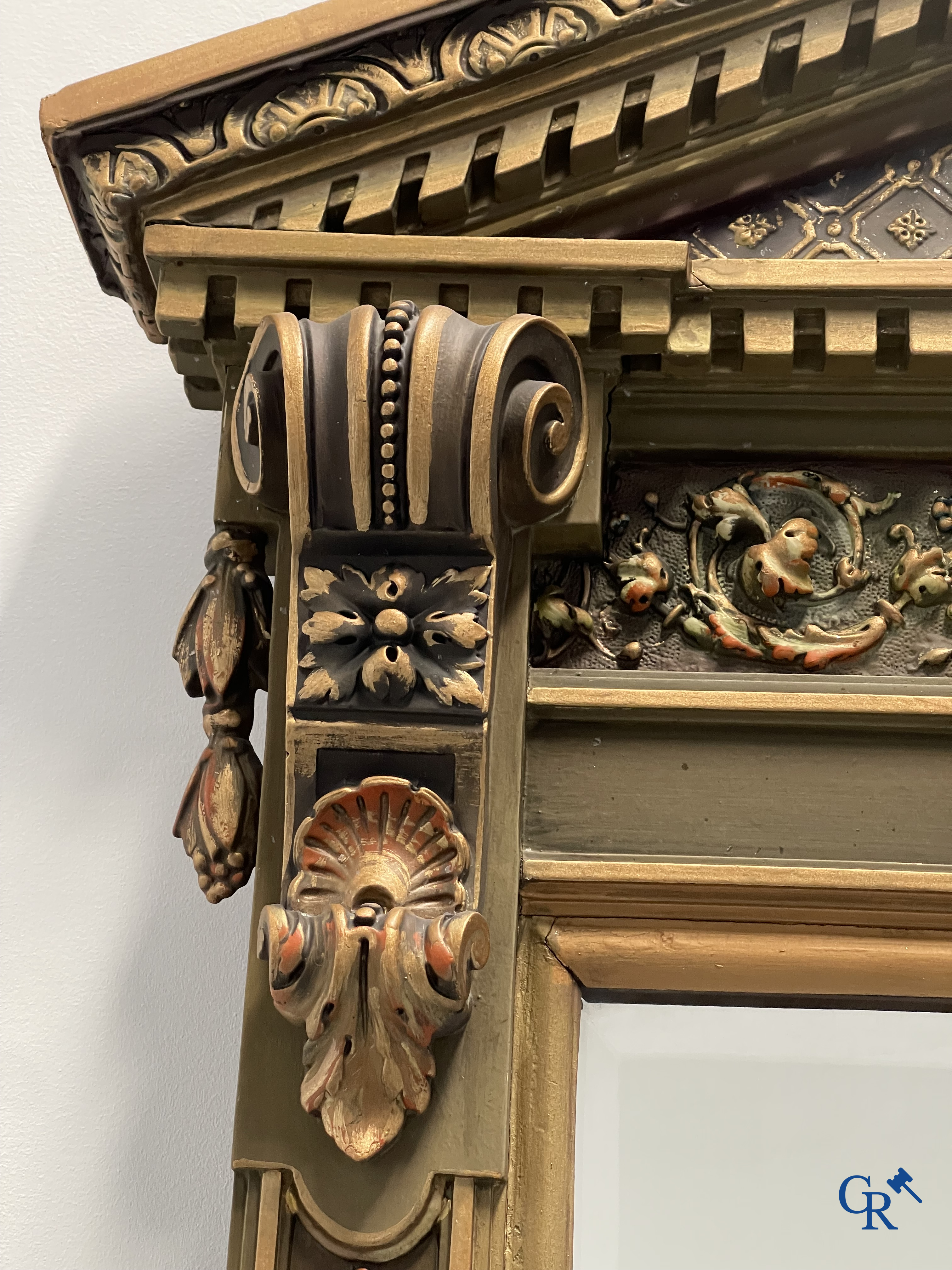 A large patinated fireplace mirror with a dragon. Around 1900.