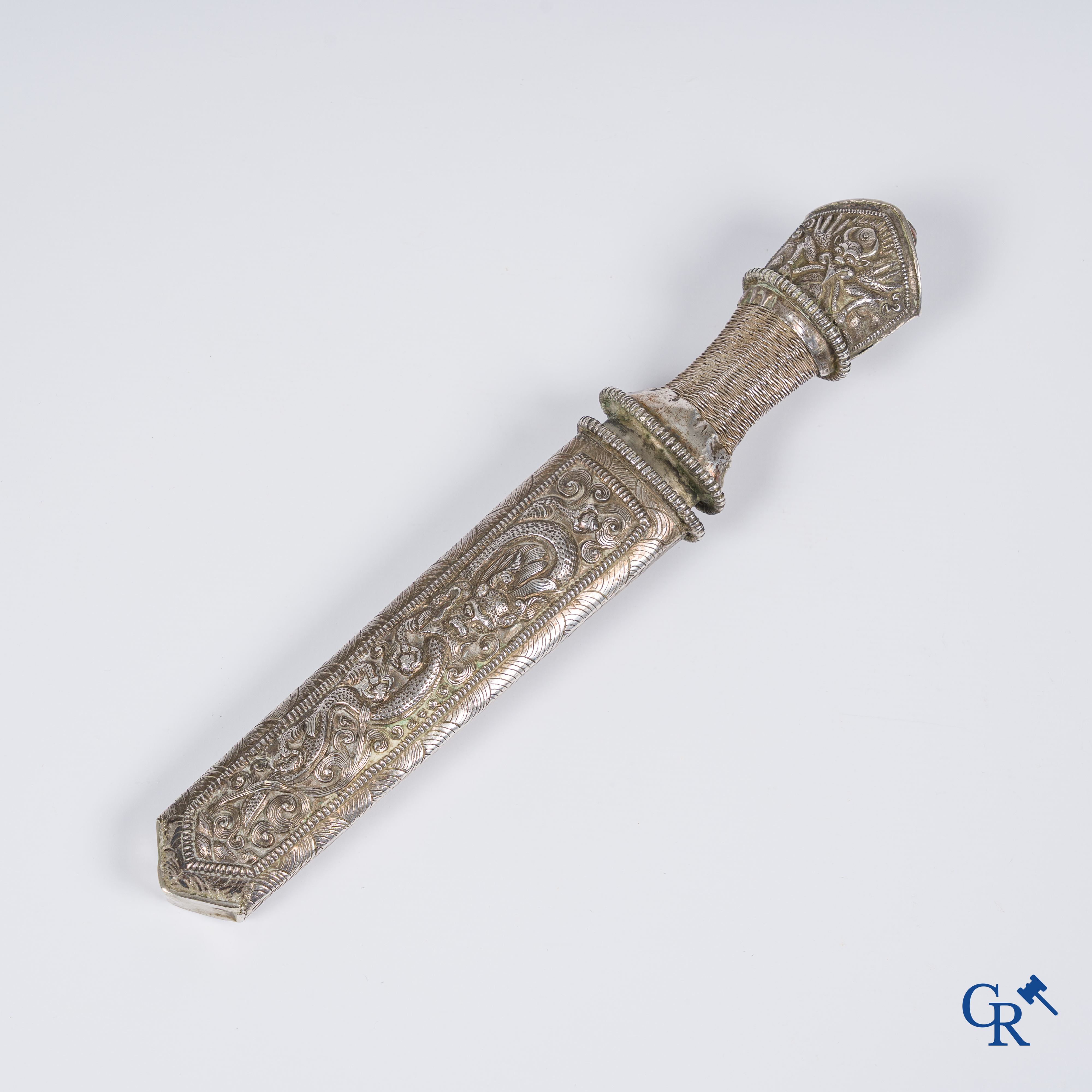 Asian Art, a richly carved silver Tibetan dagger with dragon motif. 19th century.