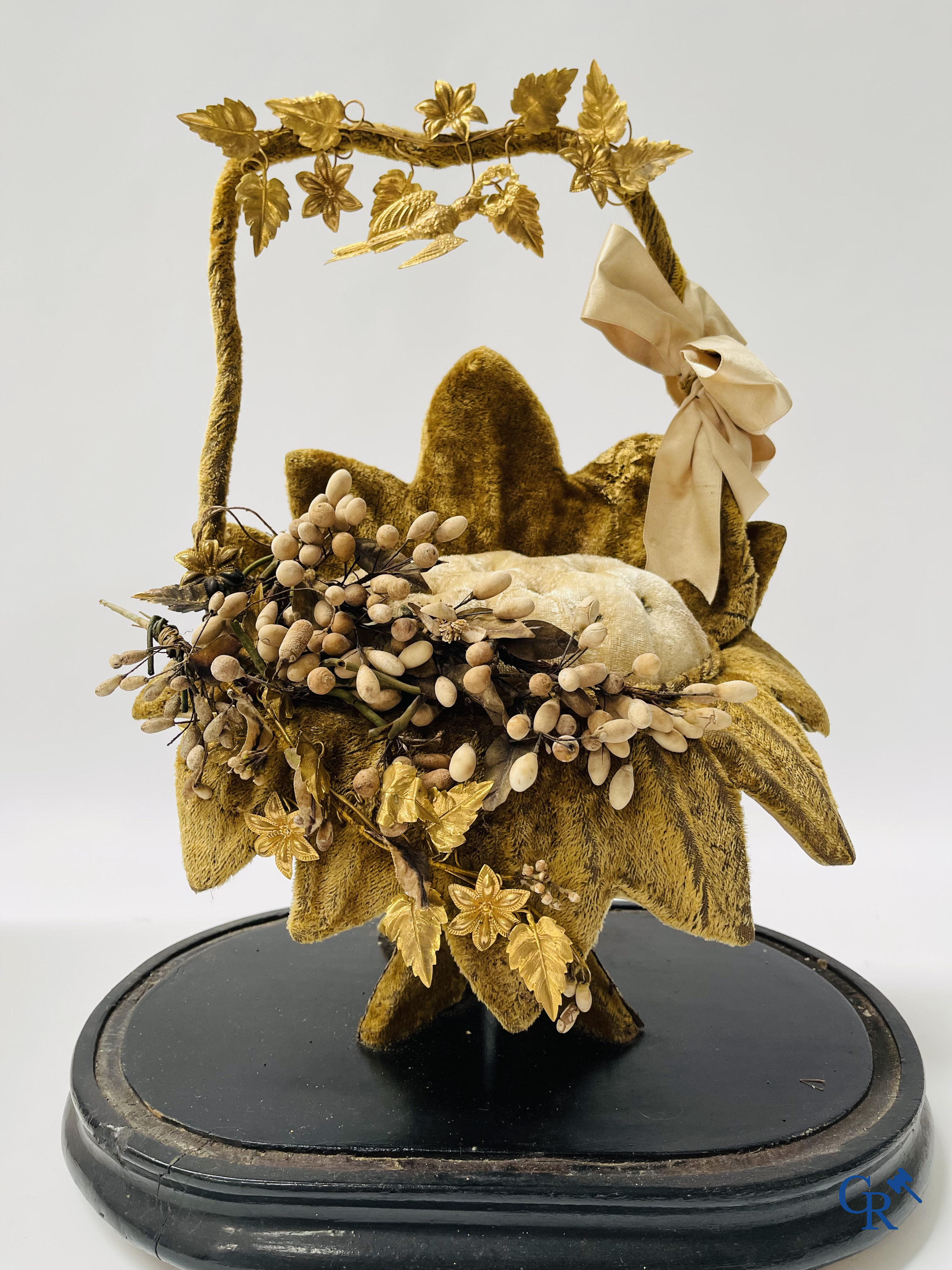 2 glass domes with a bridal bouquet on a base decorated with ornaments in gilded brass. circa 1900.