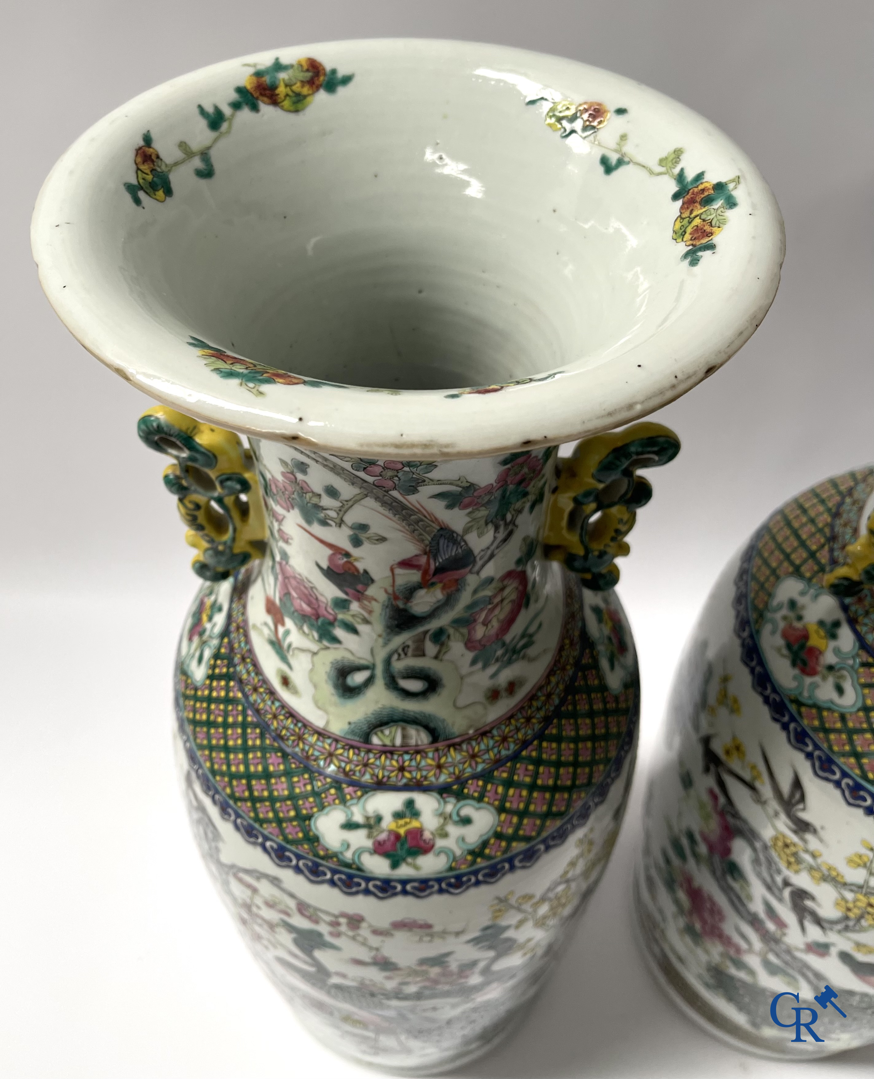 Asian Art, A pair of Chinese famille rose vases with peacocks and Fo dogs. 19th century.
