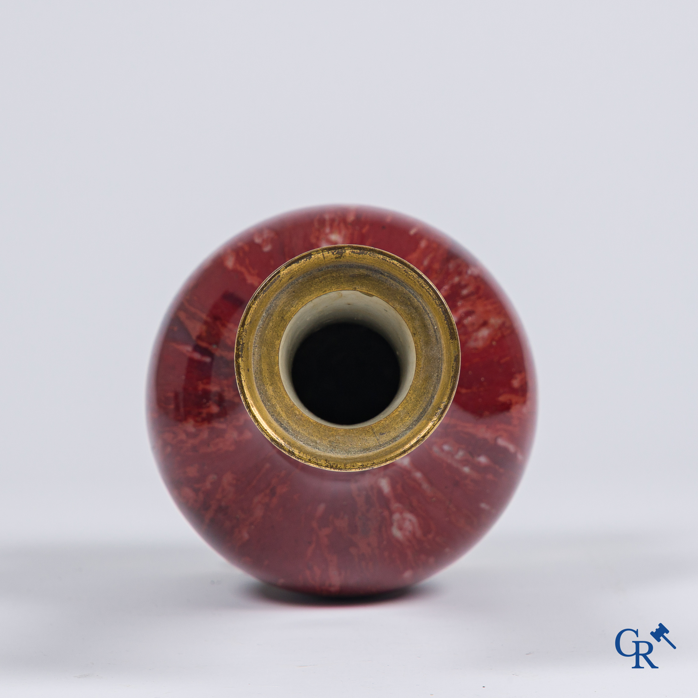 Asian Art, Chinese porcelain. A Chinese Sang de boeuf vase with gilded bronze. Marked.