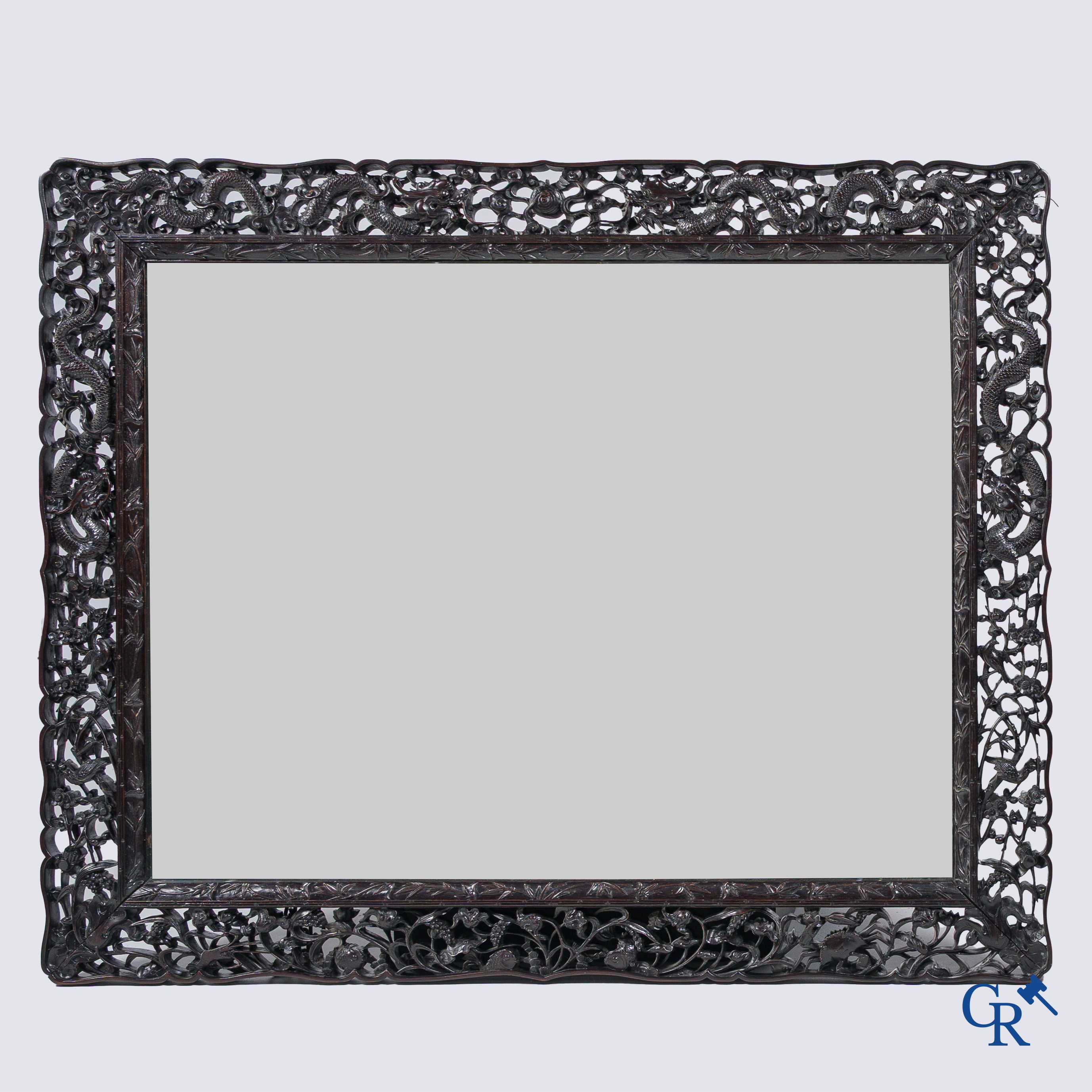 Asian Art, a large mirror in carved Chinese hardwood. 19th century.
