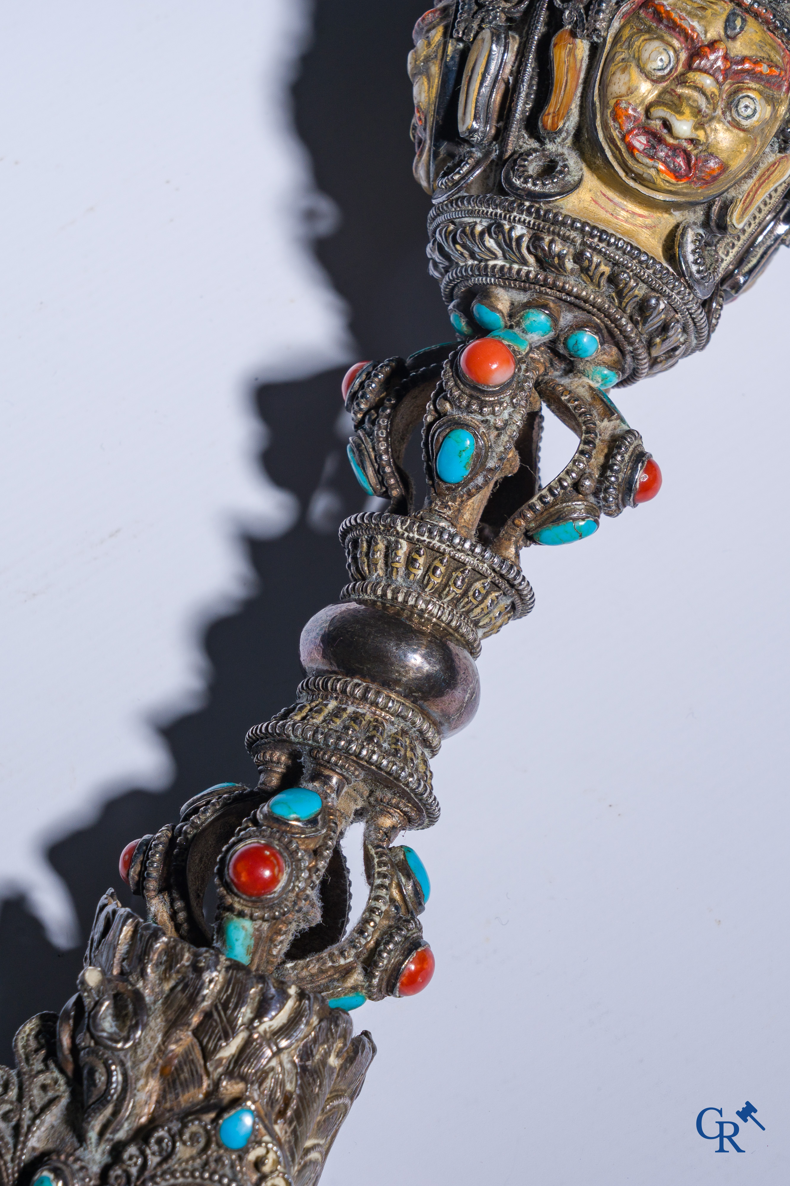 Asian Art, Phurba. Tibetan ritual dagger in silver, inlaid with turquoise and red coral.