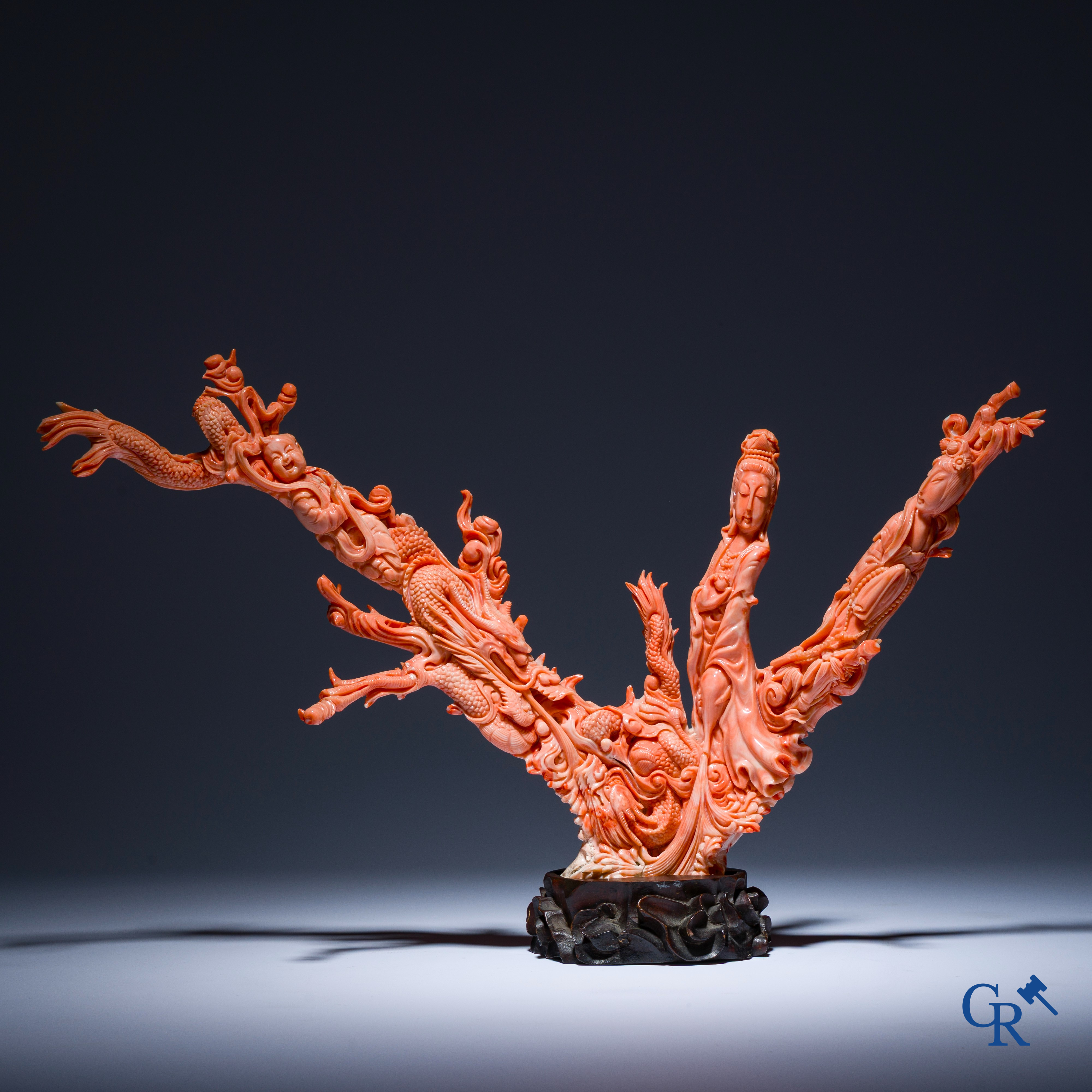 Asian Art, A Chinese group in finely carved red coral with ladies, dragons and children. 19th century.