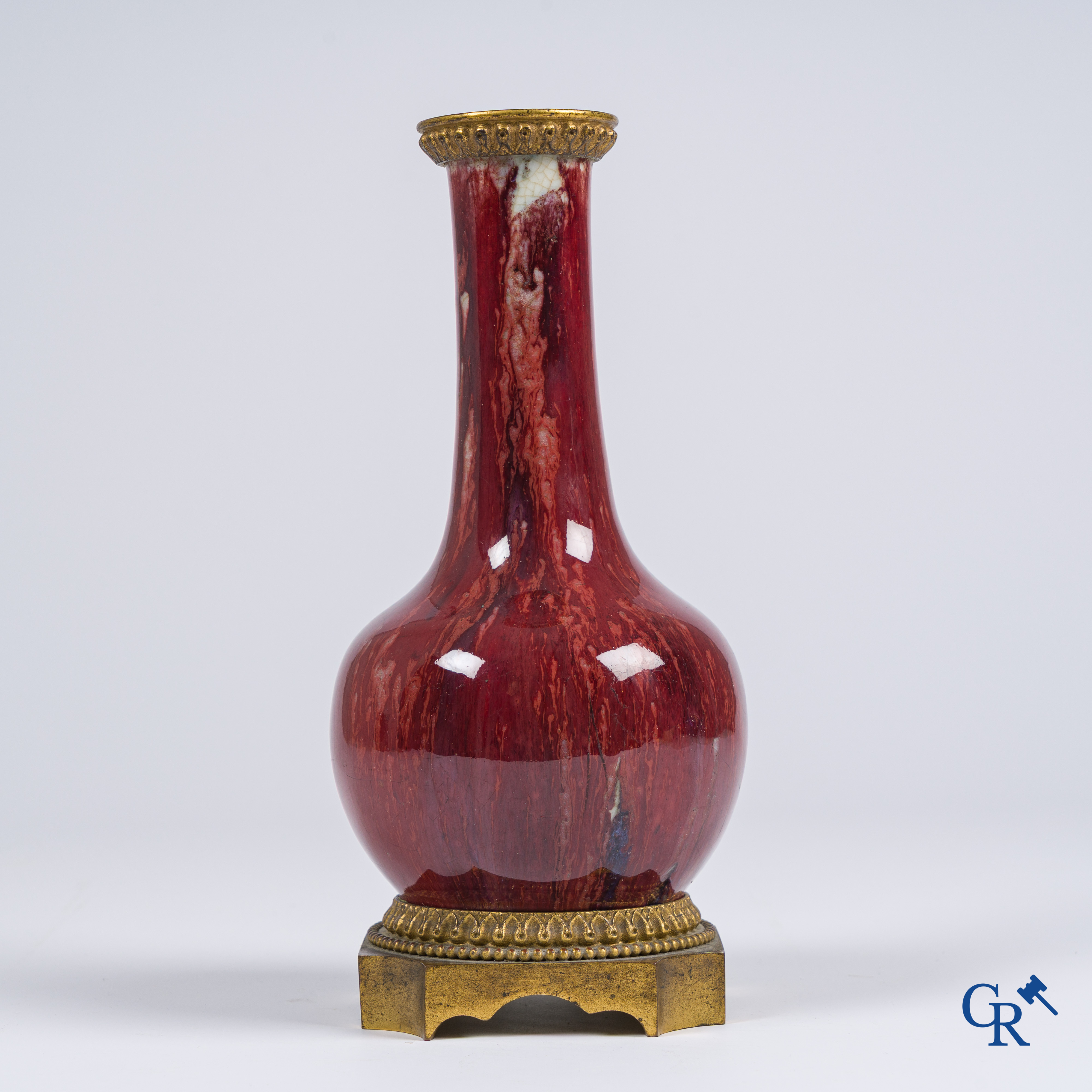 Asian Art, Chinese porcelain. A Chinese Sang de boeuf vase with gilded bronze. Marked.