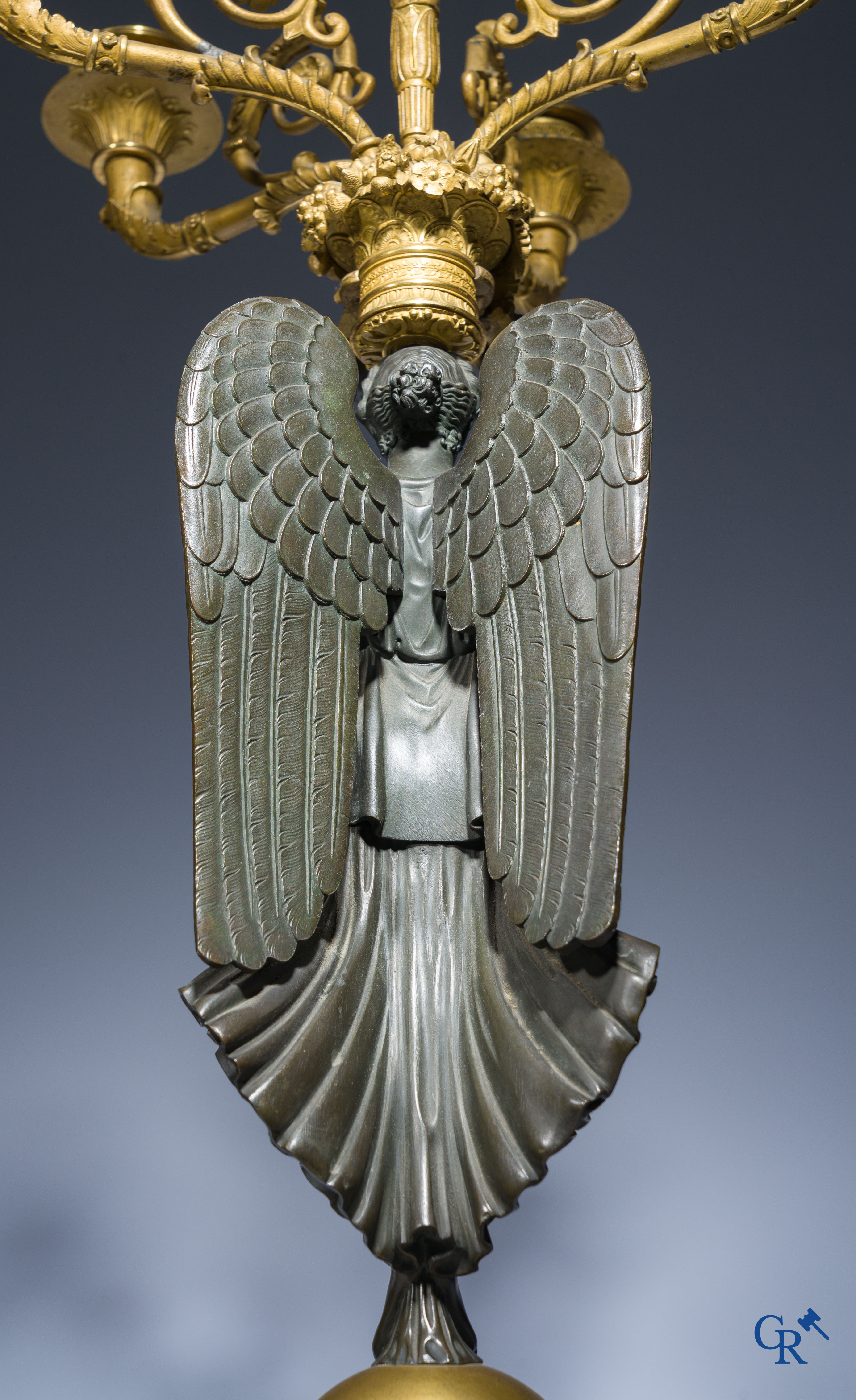 Empire, A pair of large gilded and patinated bronze candlesticks with winged women, circa 1810.