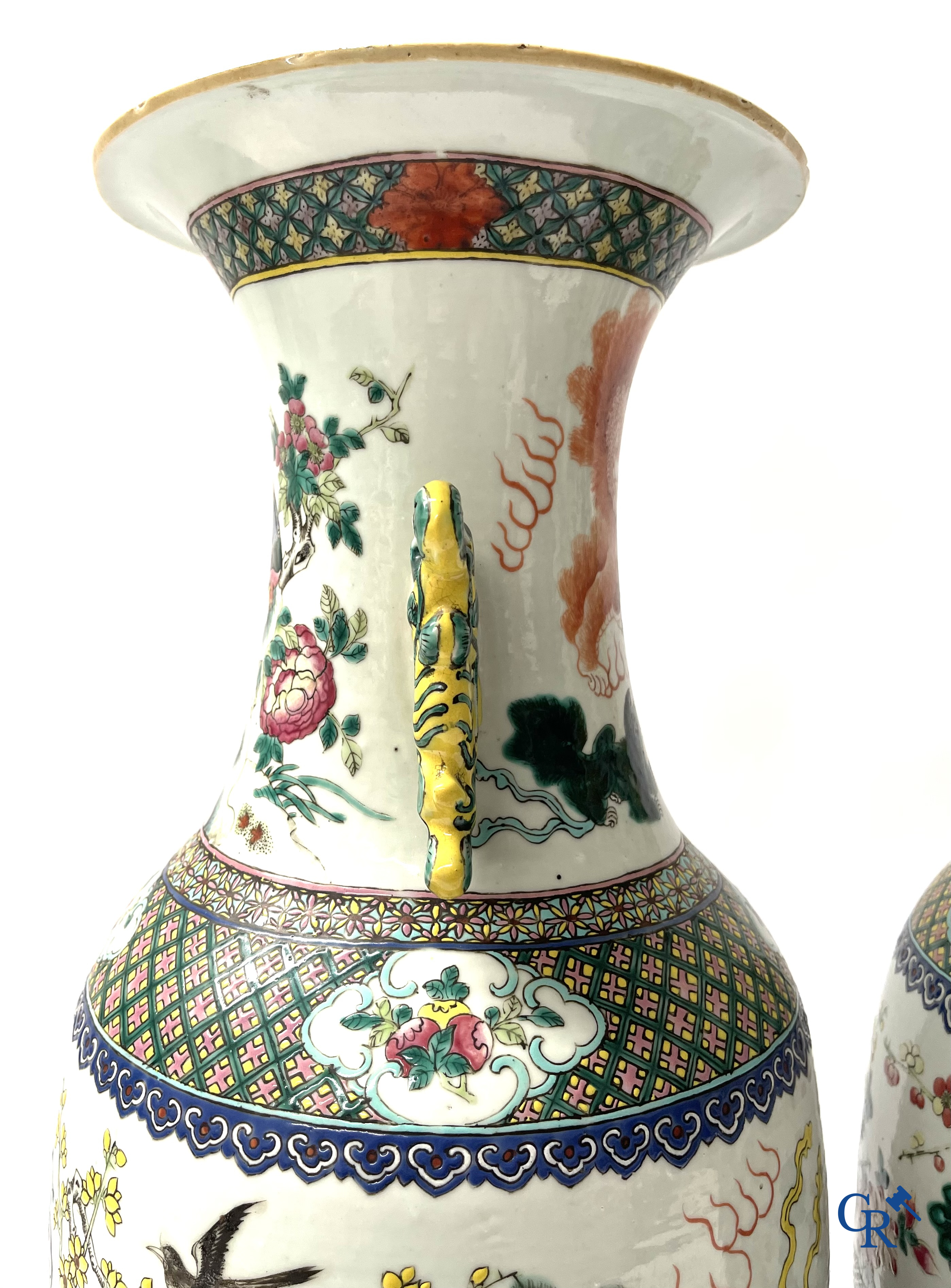 Asian Art, A pair of Chinese famille rose vases with peacocks and Fo dogs. 19th century.