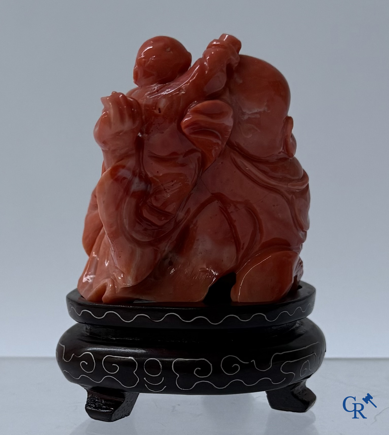 Asian Art, a Chinese carved red coral Buddha figure with child.