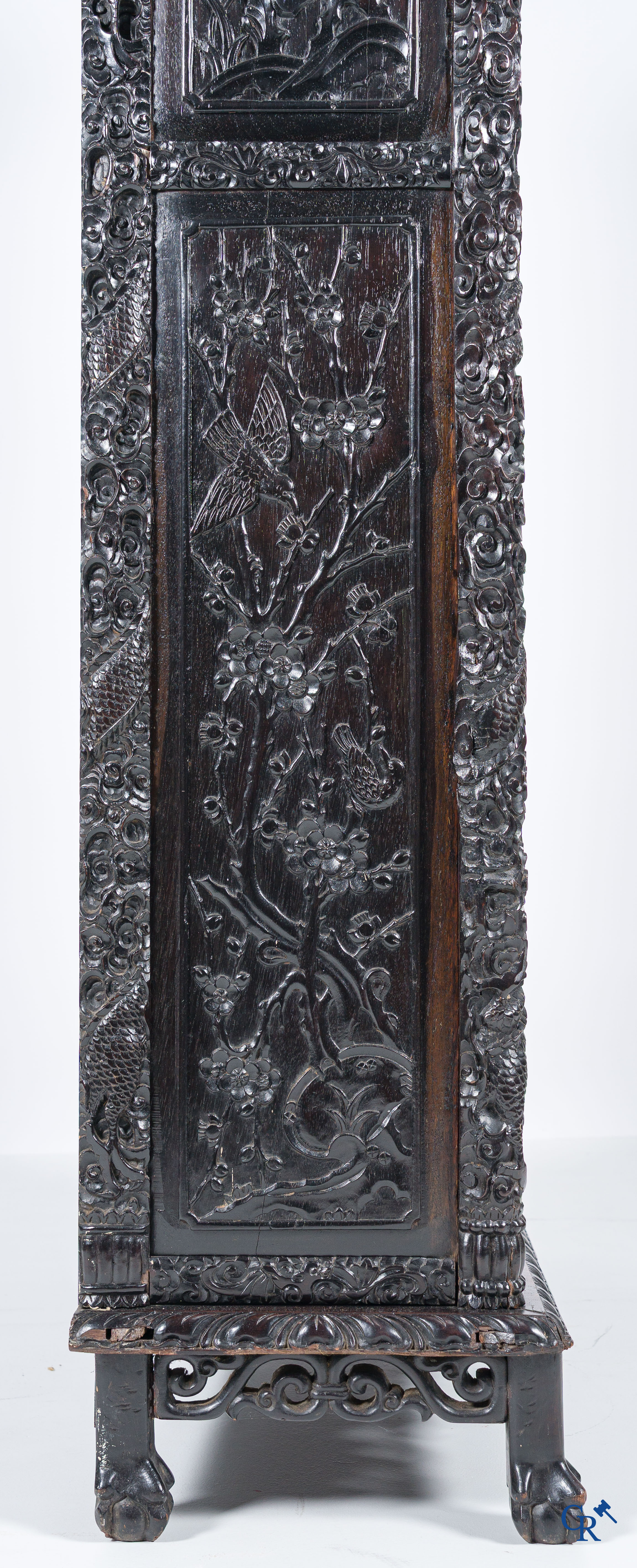 Asian Art, a 2-door display cabinet in finely carved Chinese hardwood. 19th century.