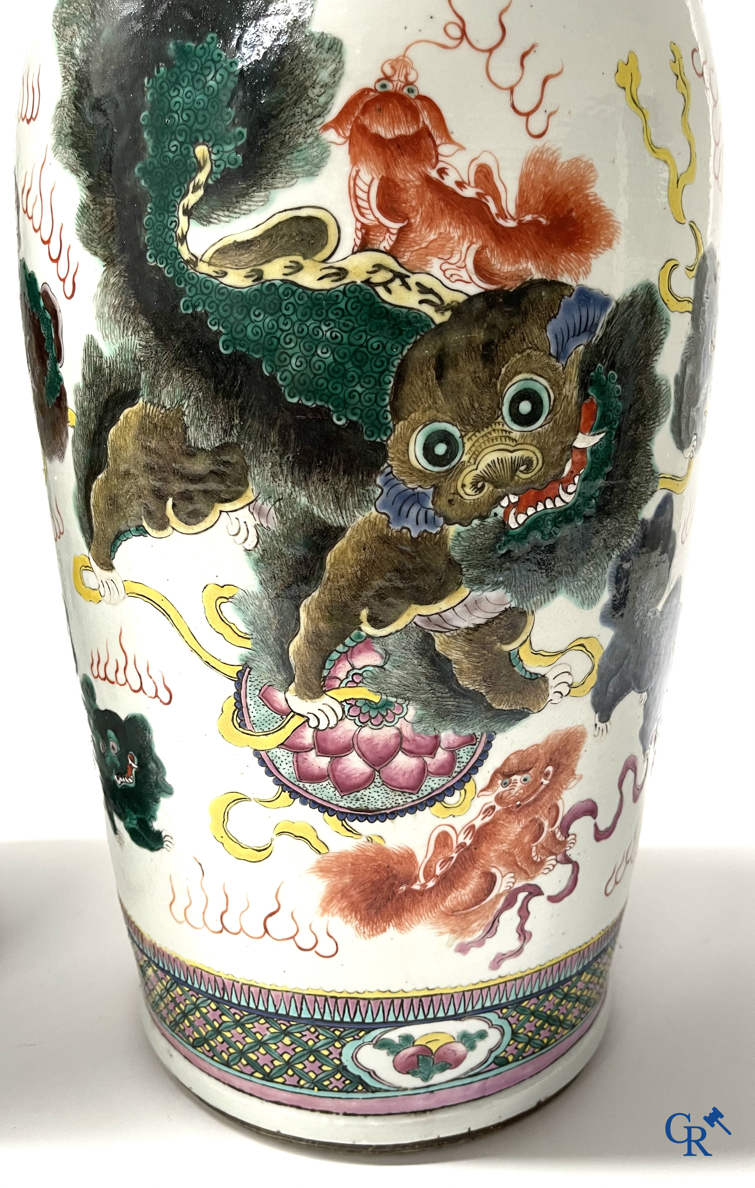 Asian Art, A pair of Chinese famille rose vases with peacocks and Fo dogs. 19th century.