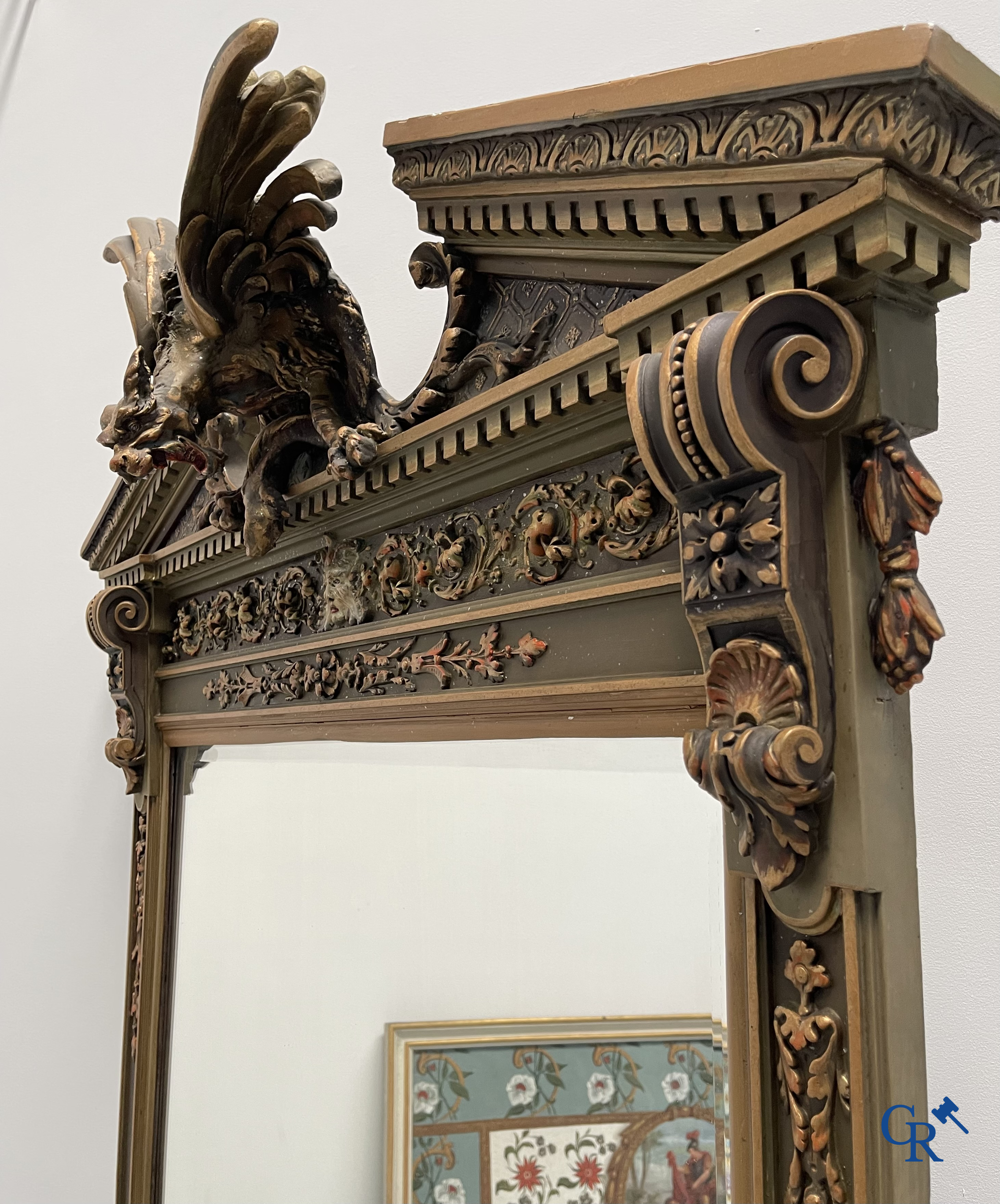 A large patinated fireplace mirror with a dragon. Around 1900.