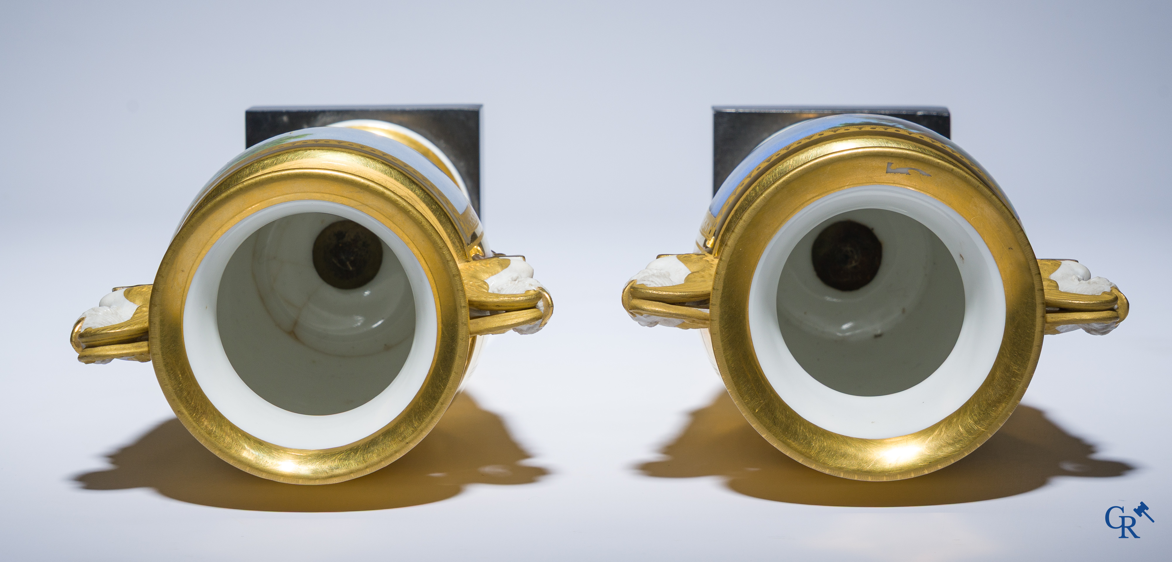 Empire, a pair of finely gilded and decorated vases in porcelain and biscuit on a marble pedestal, Circa 1810.