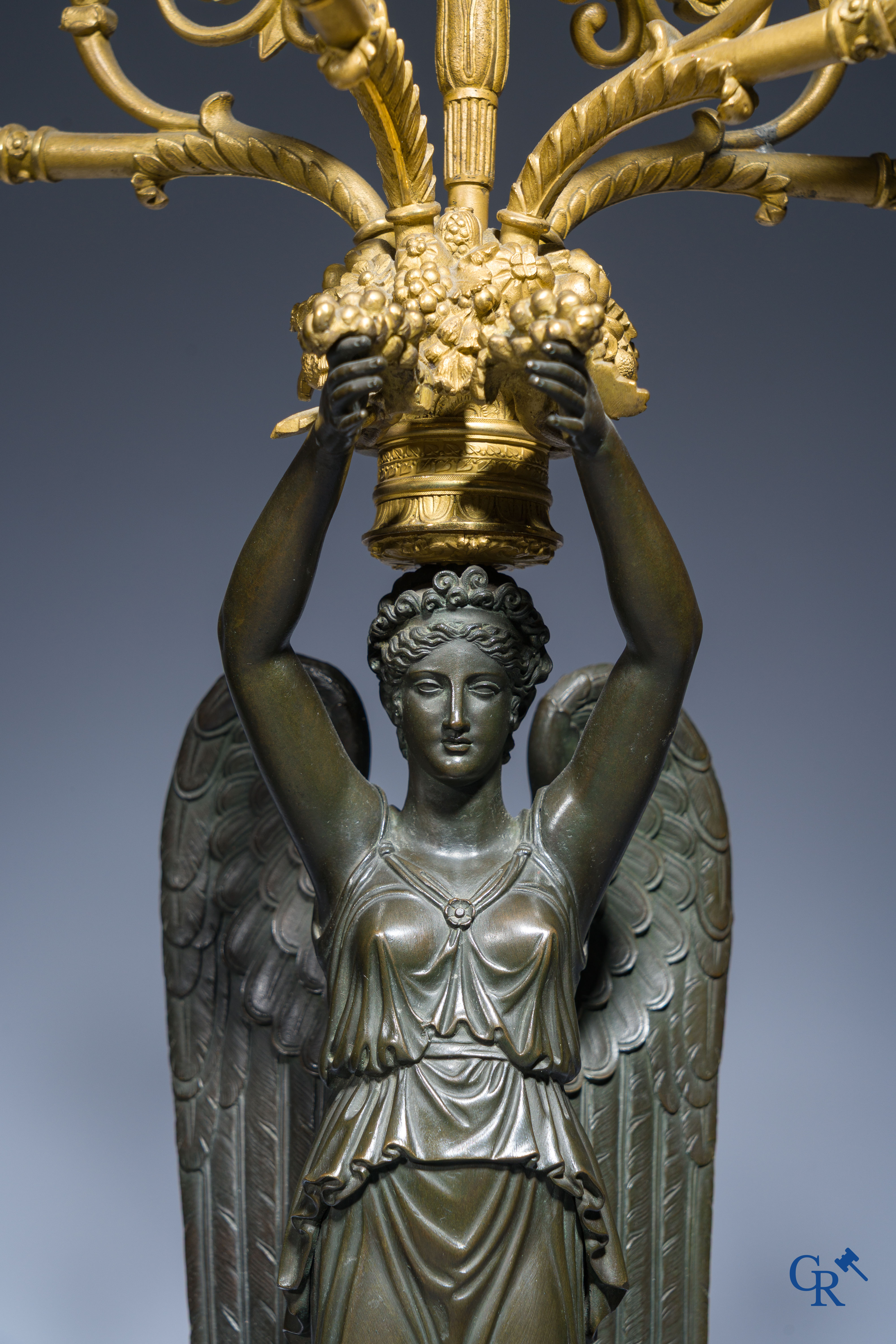 Empire, A pair of large gilded and patinated bronze candlesticks with winged women, circa 1810.