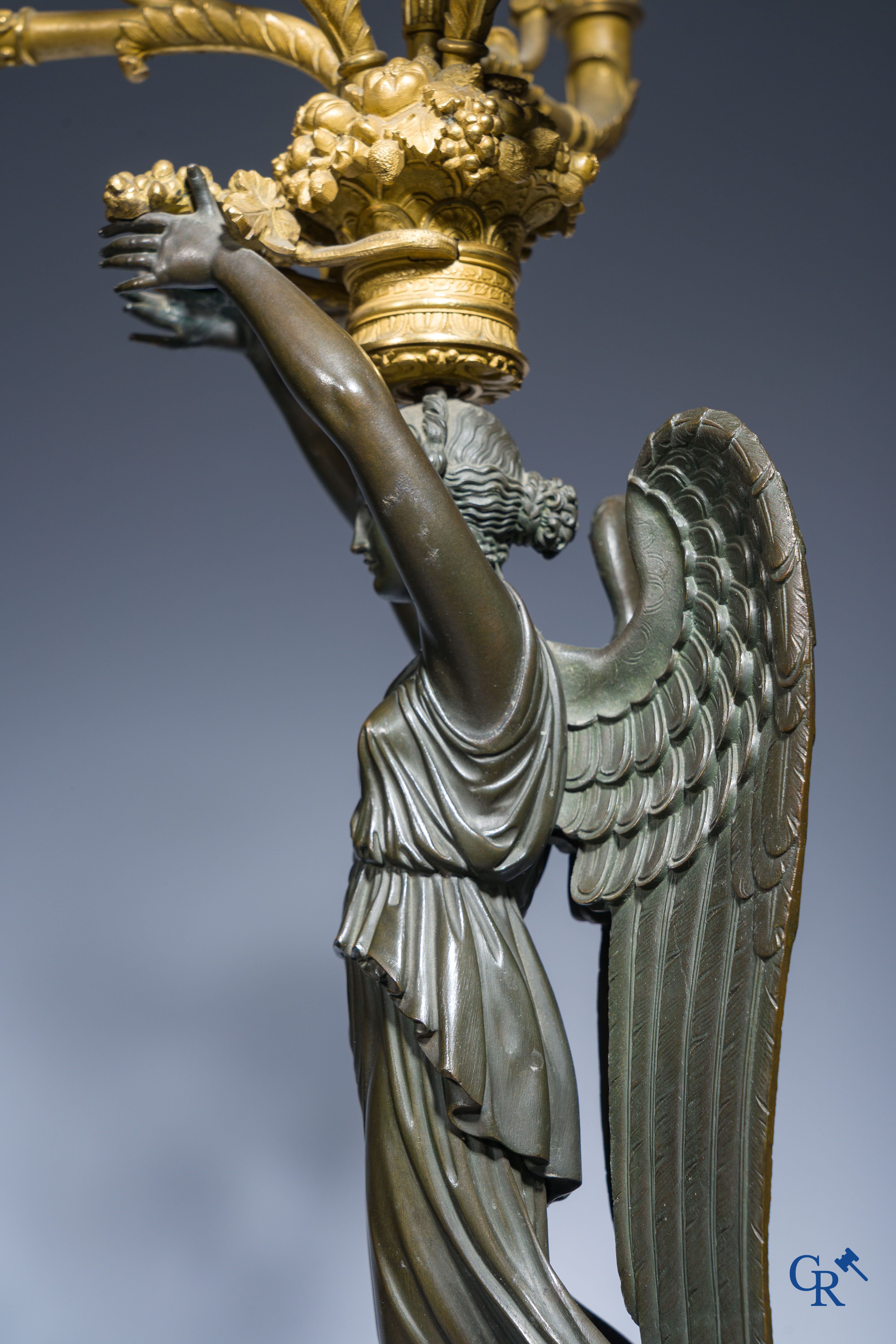 Empire, A pair of large gilded and patinated bronze candlesticks with winged women, circa 1810.
