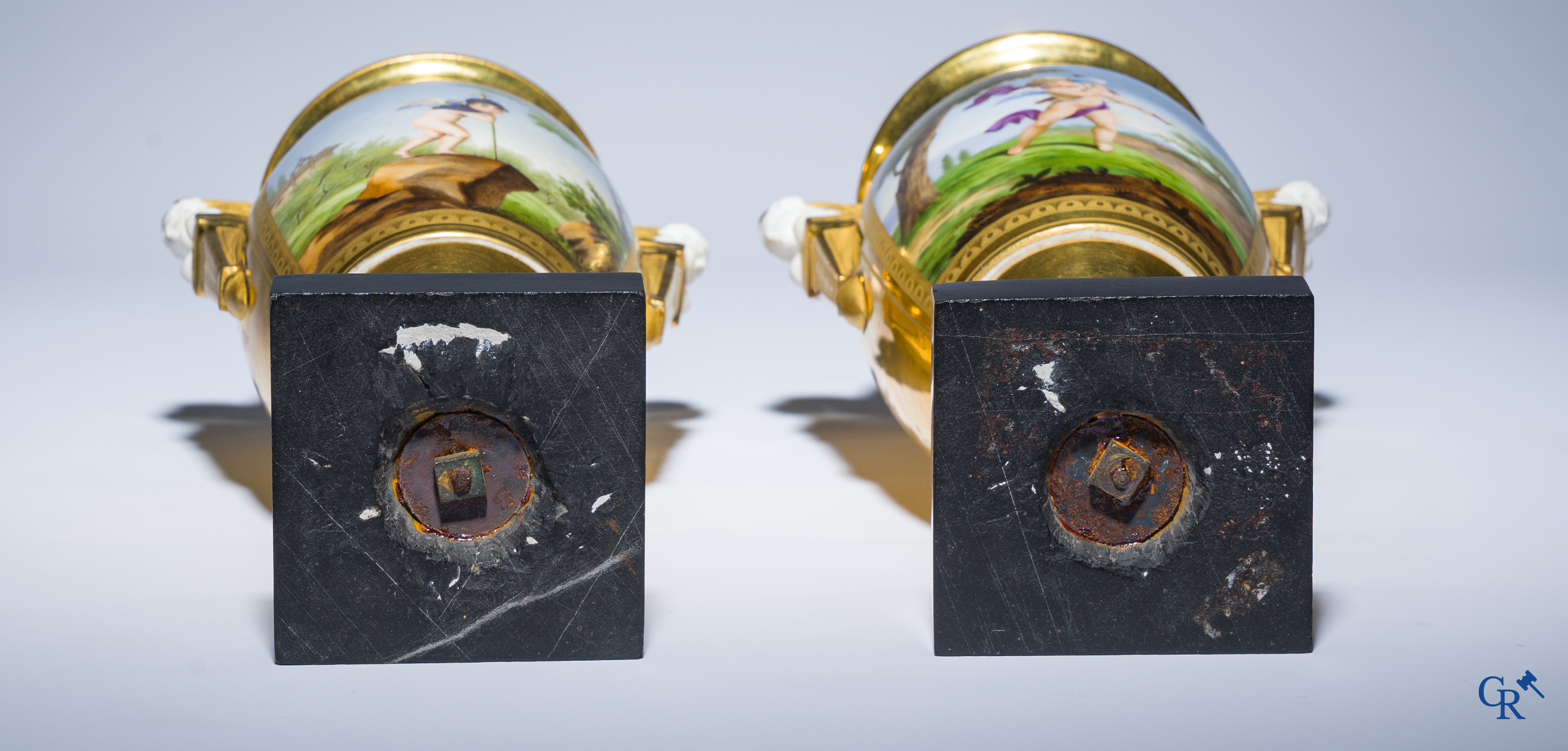 Empire, a pair of finely gilded and decorated vases in porcelain and biscuit on a marble pedestal, Circa 1810.