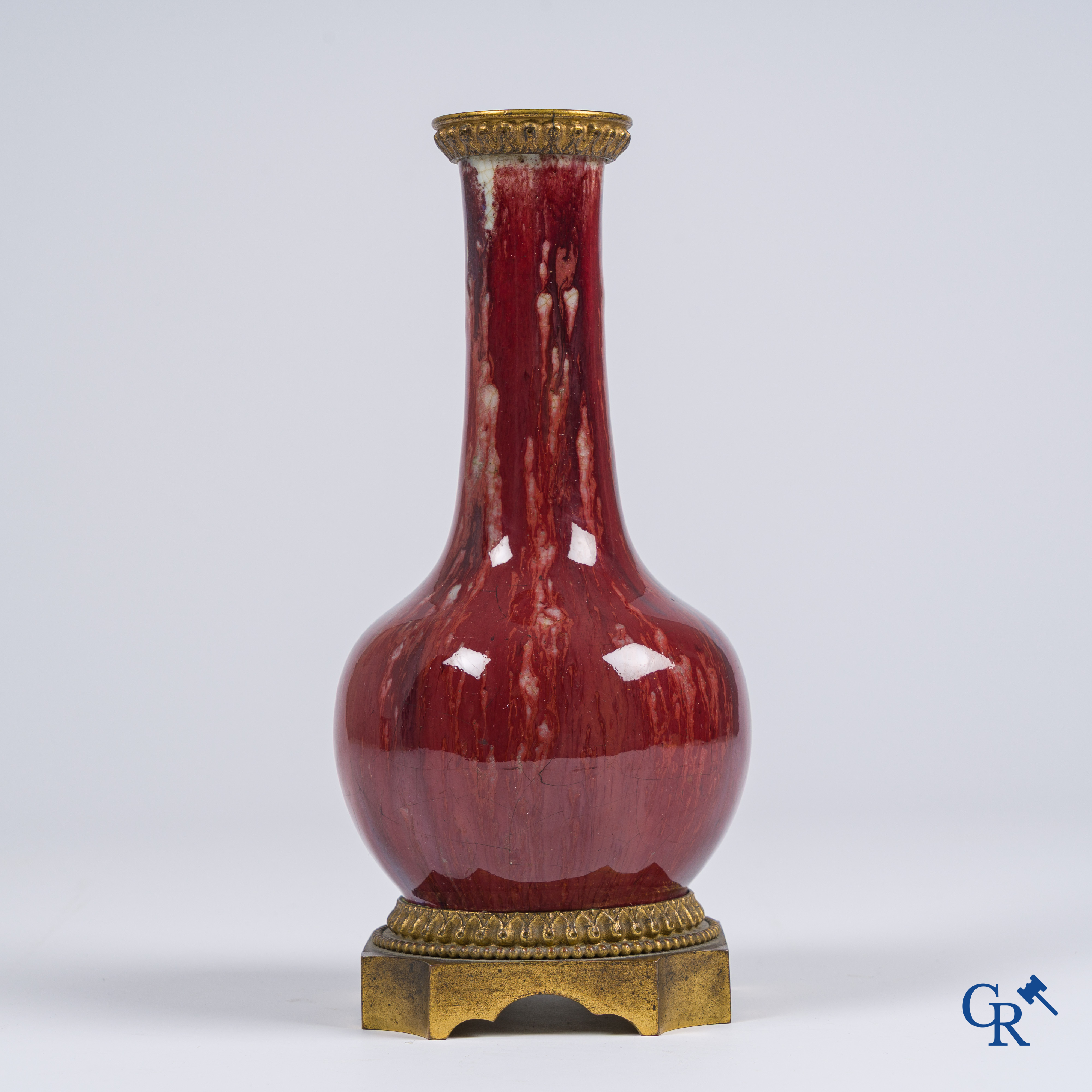 Asian Art, Chinese porcelain. A Chinese Sang de boeuf vase with gilded bronze. Marked.