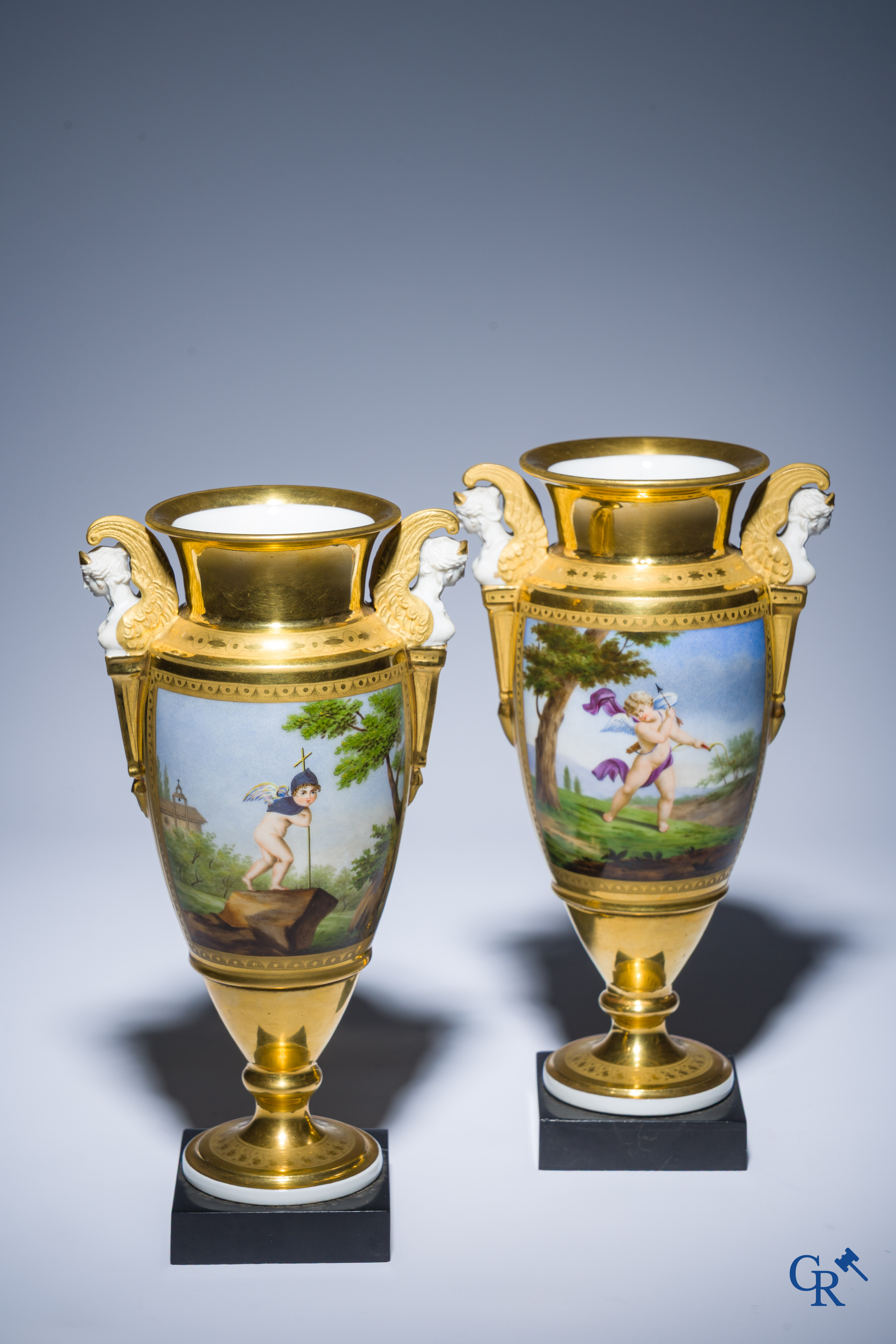 Empire, a pair of finely gilded and decorated vases in porcelain and biscuit on a marble pedestal, Circa 1810.