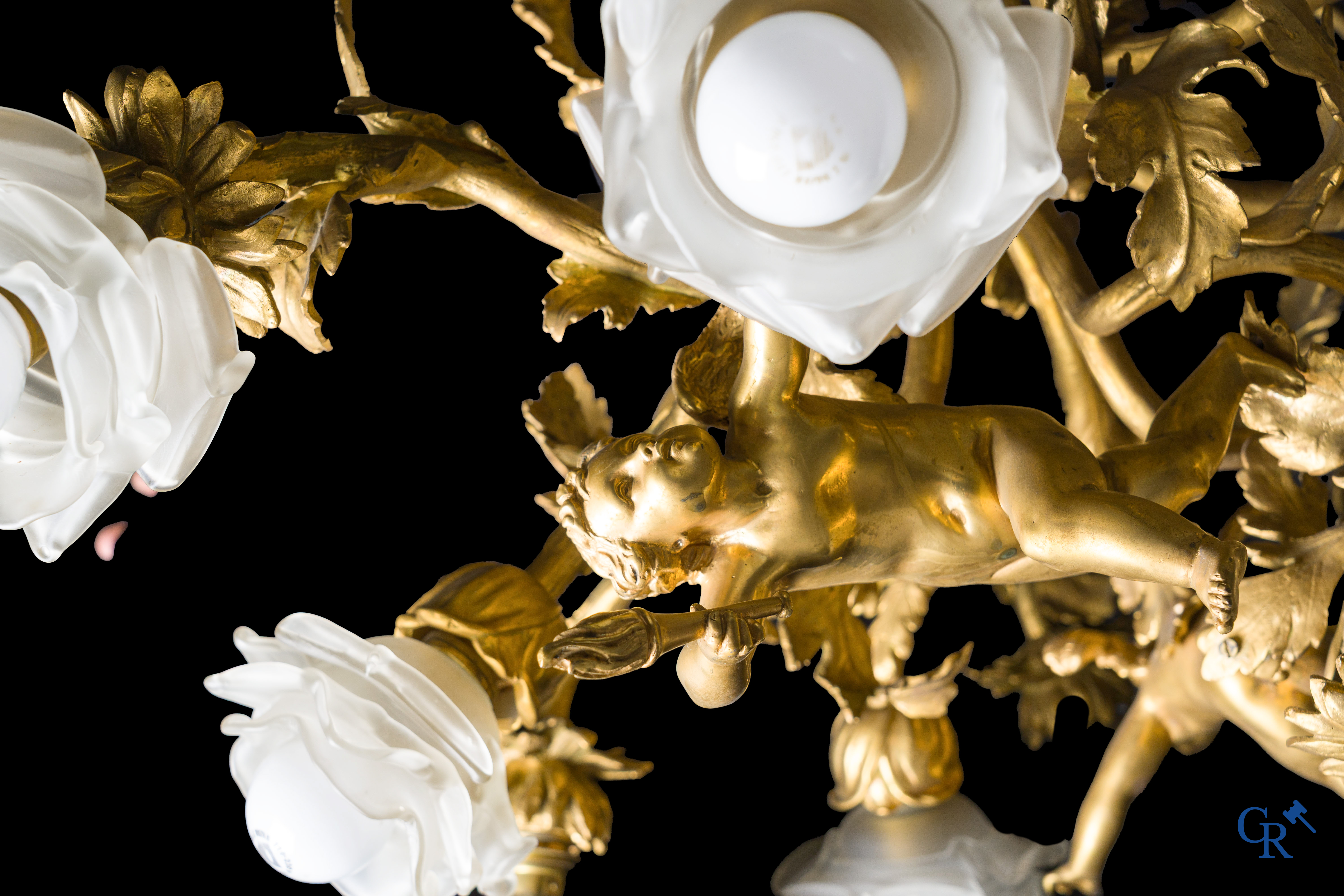 An imposing bronze gilded Napoleon III chandelier with 3 putti and 13 light points. LXVI style.
