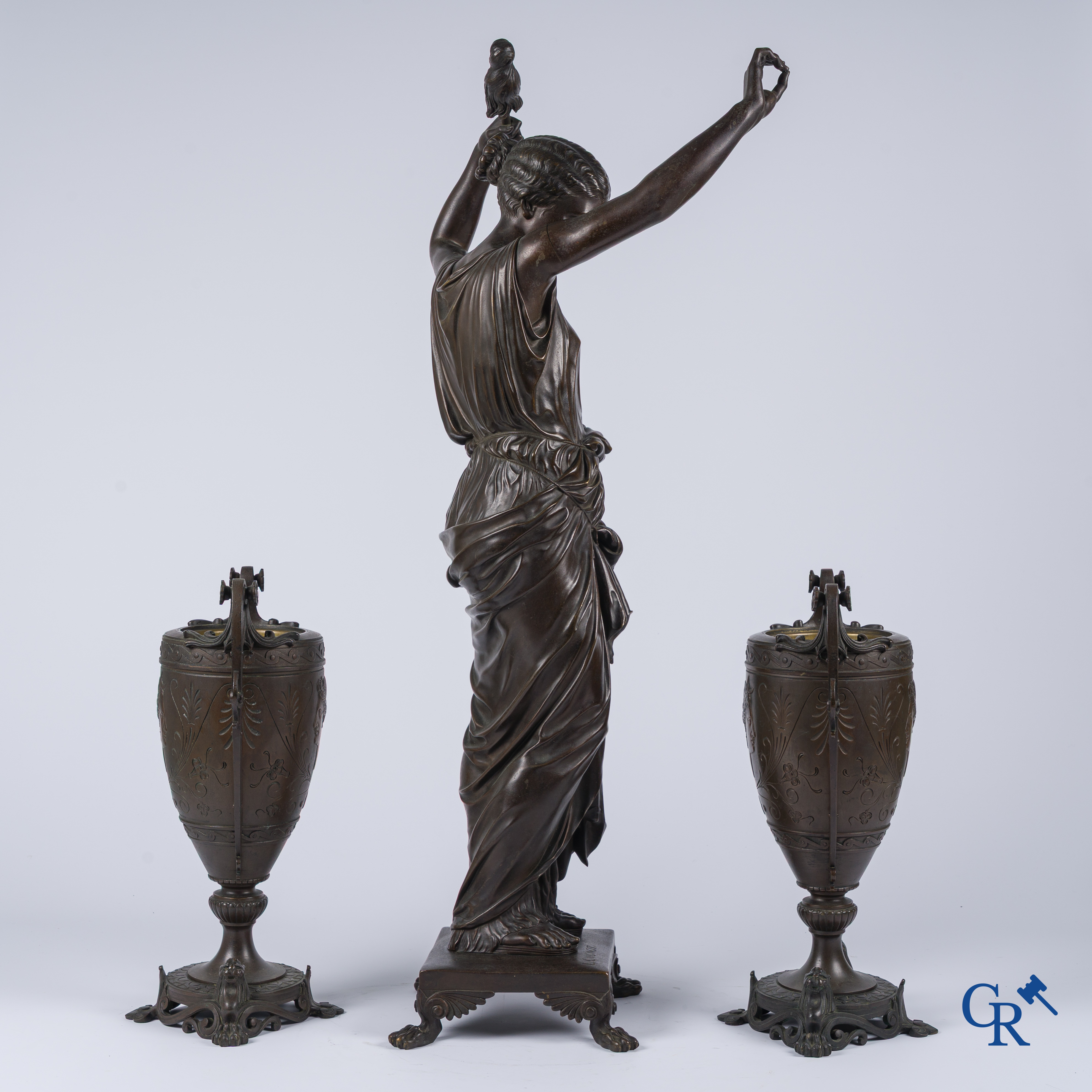 Louis Léon Cugnot (1835-1894) A large 3-piece bronze chimney set "La Fileuse" Signed L. Cugnot.