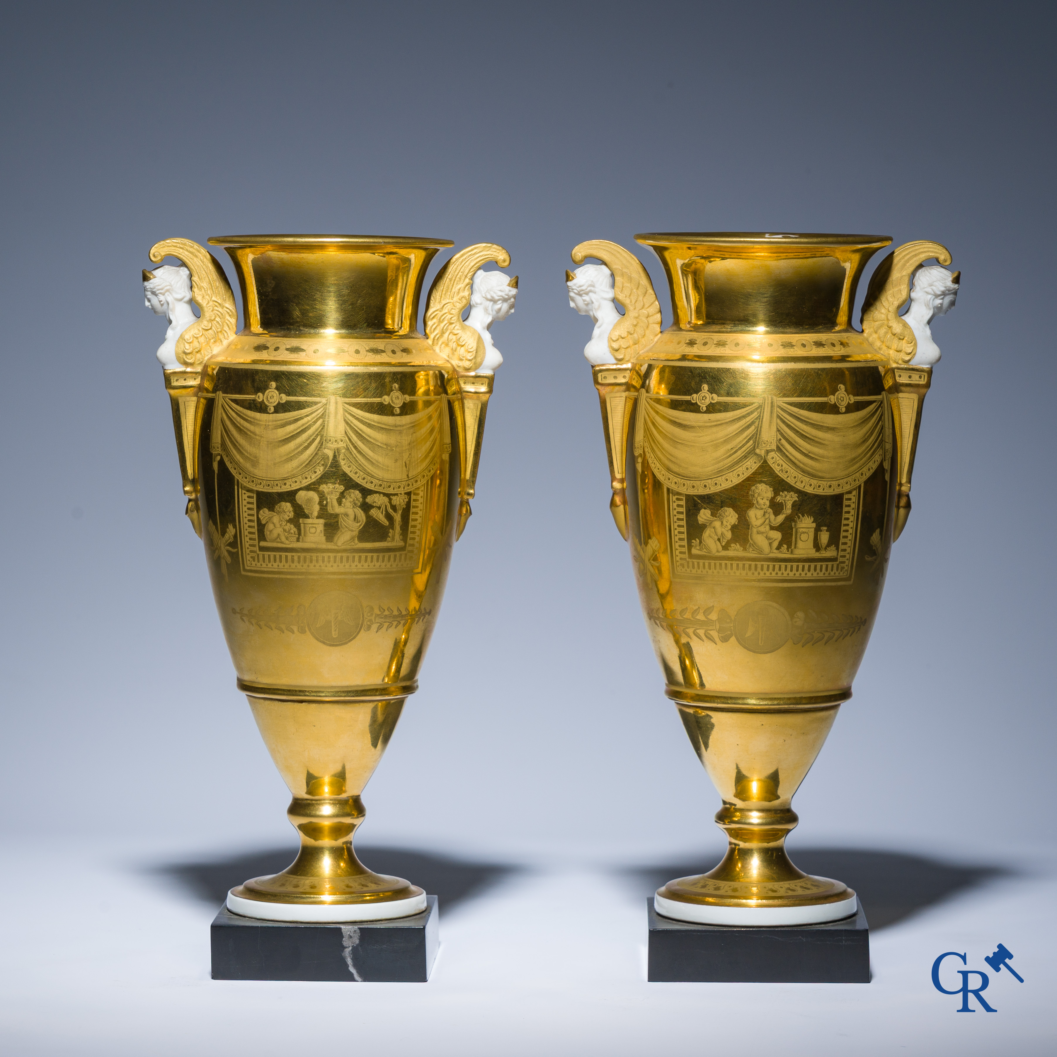 Empire, a pair of finely gilded and decorated vases in porcelain and biscuit on a marble pedestal, Circa 1810.