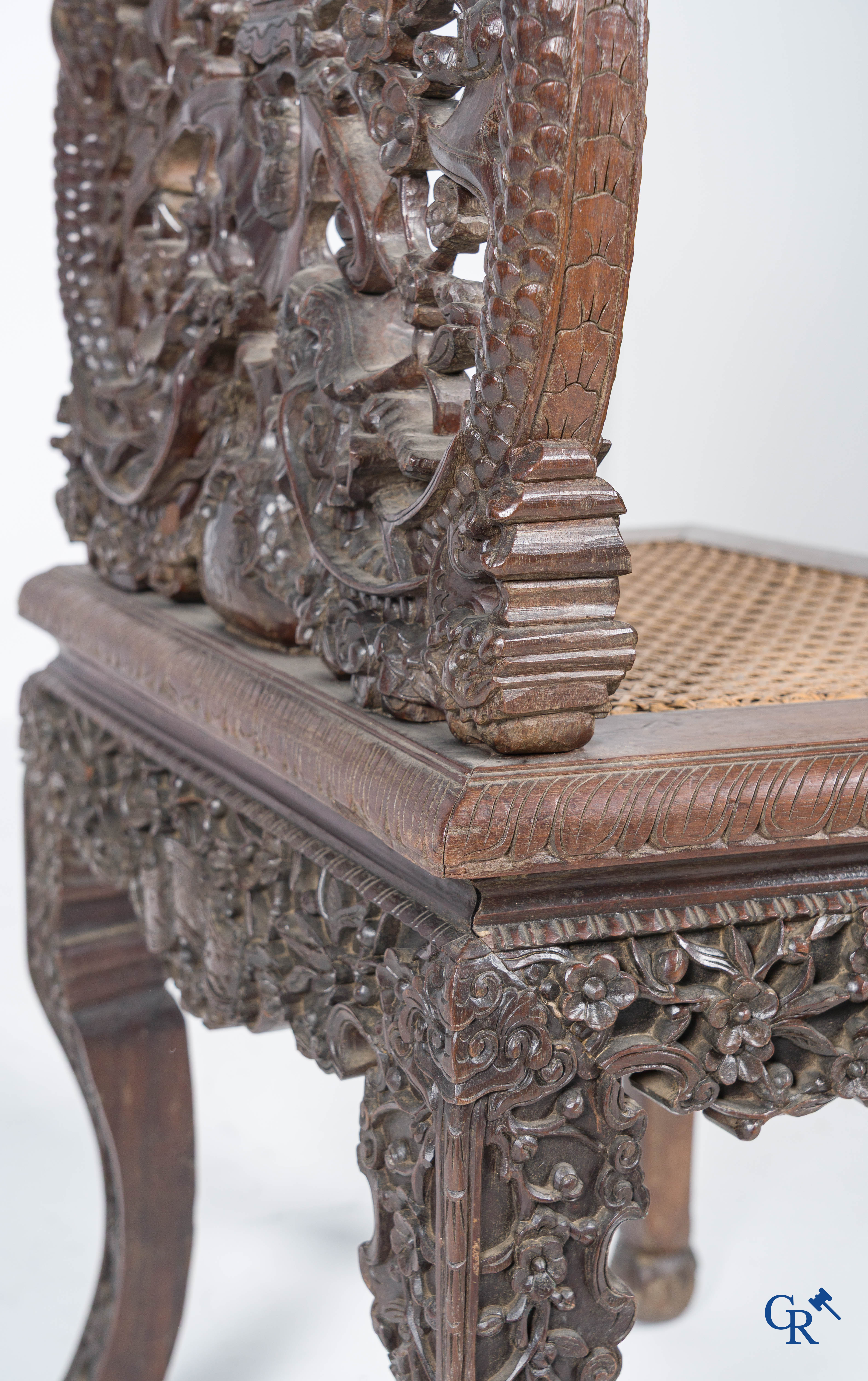 Asian Art, A pair of richly carved chairs with bats, dragons and flowers in Chinese hardwood. 19th century.