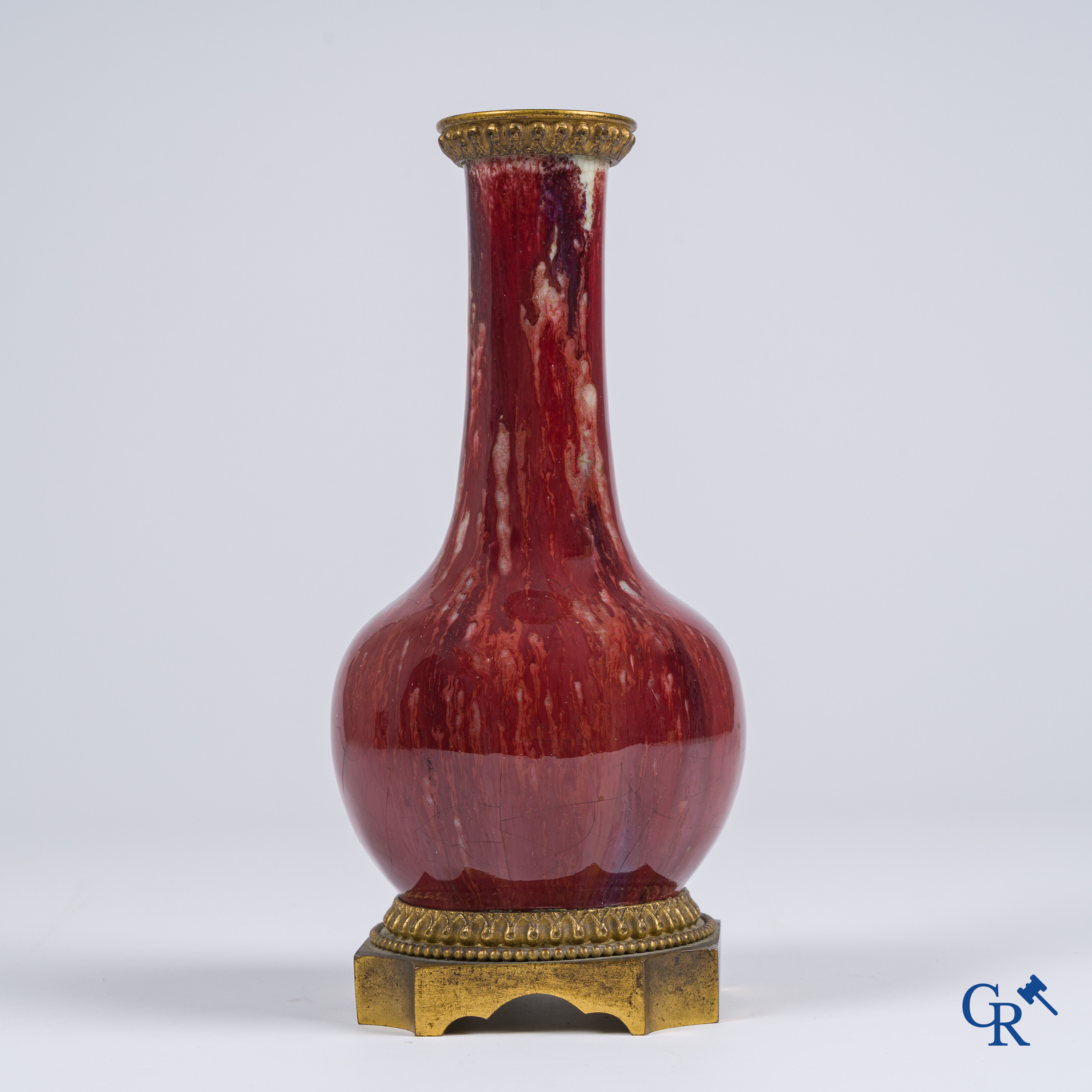 Asian Art, Chinese porcelain. A Chinese Sang de boeuf vase with gilded bronze. Marked.