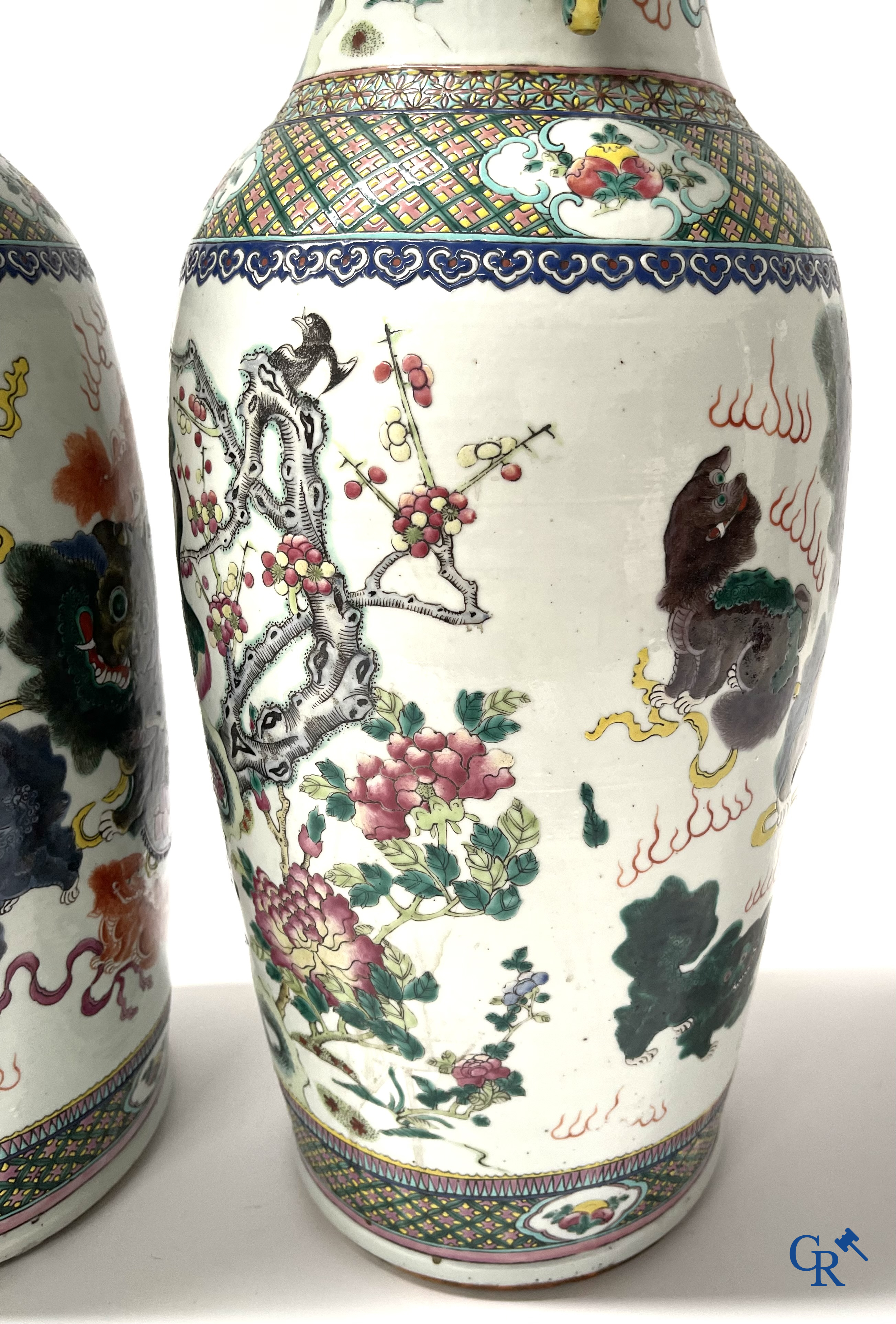 Asian Art, A pair of Chinese famille rose vases with peacocks and Fo dogs. 19th century.