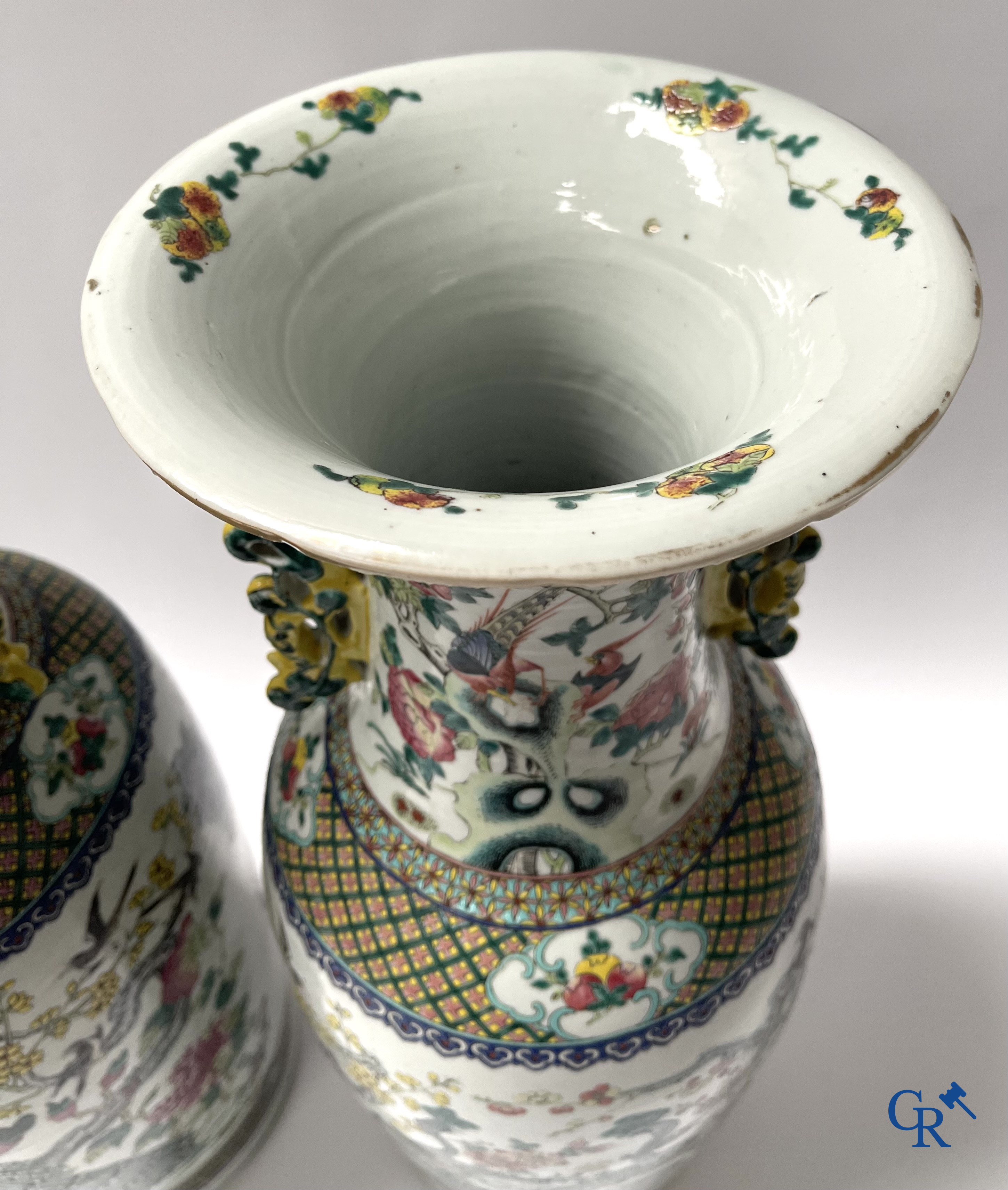 Asian Art, A pair of Chinese famille rose vases with peacocks and Fo dogs. 19th century.