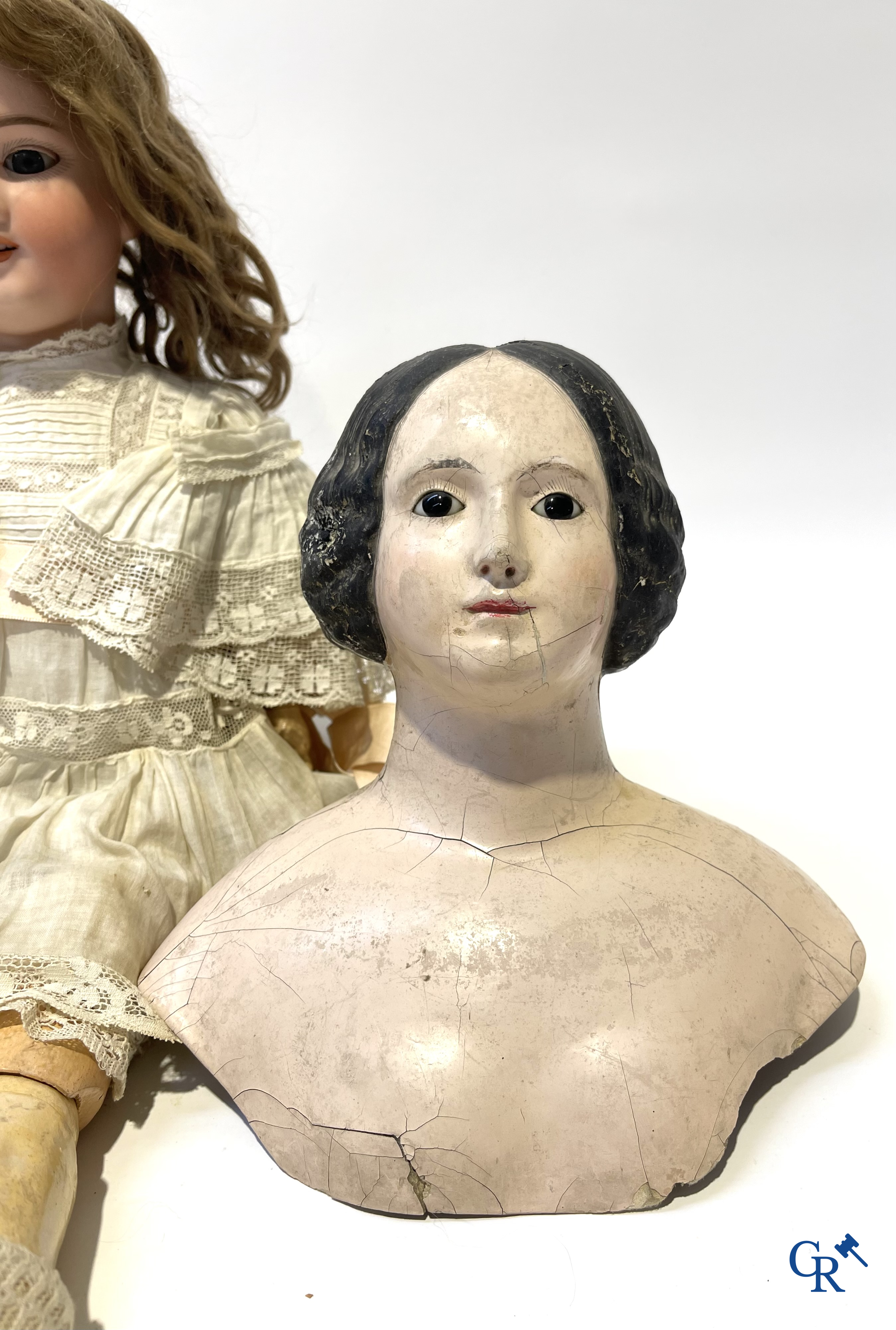 Old toys, an antique doll with porcelain head marked Armand Marseille and a bust in papier-mâché.