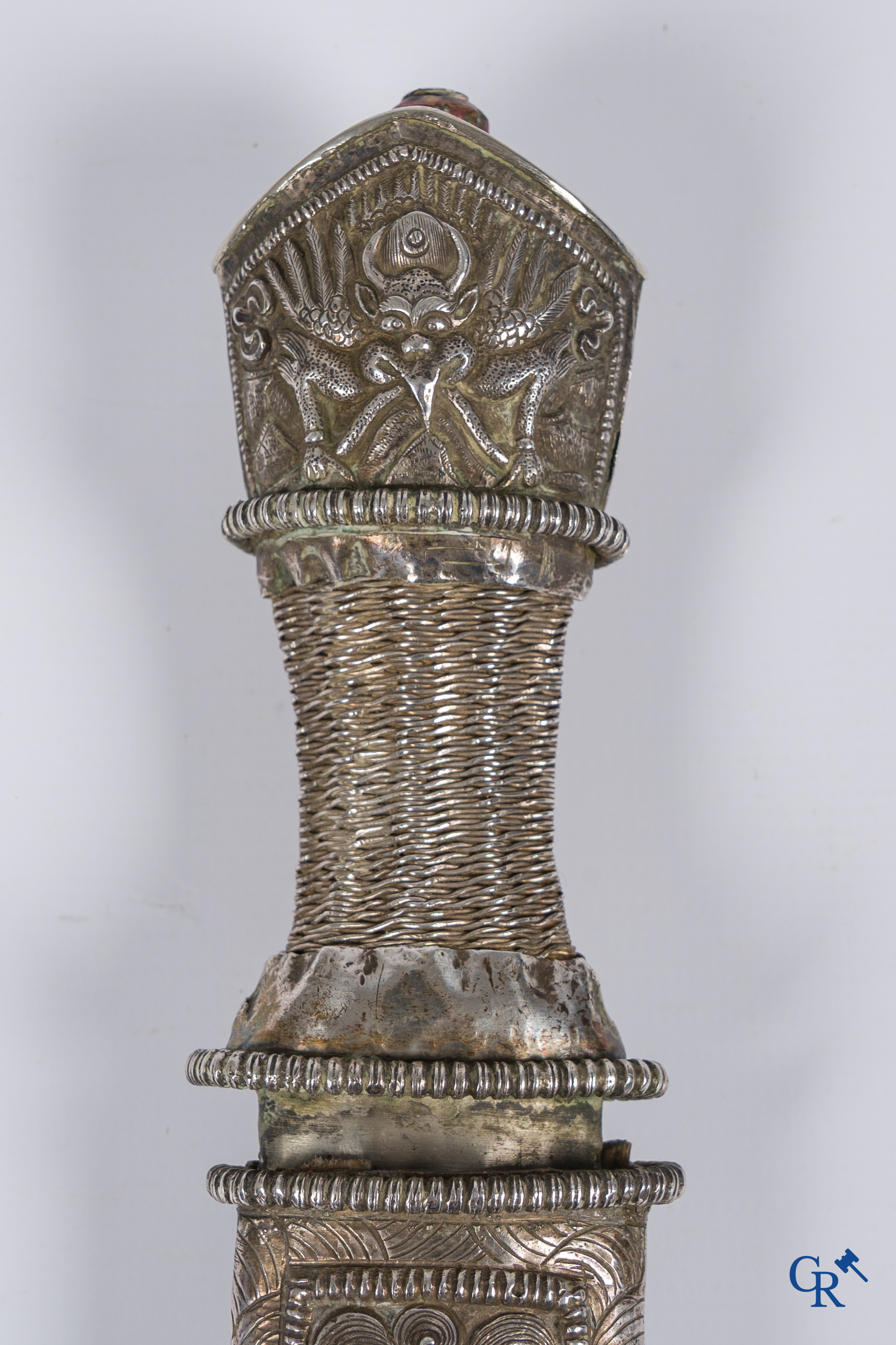 Asian Art, a richly carved silver Tibetan dagger with dragon motif. 19th century.