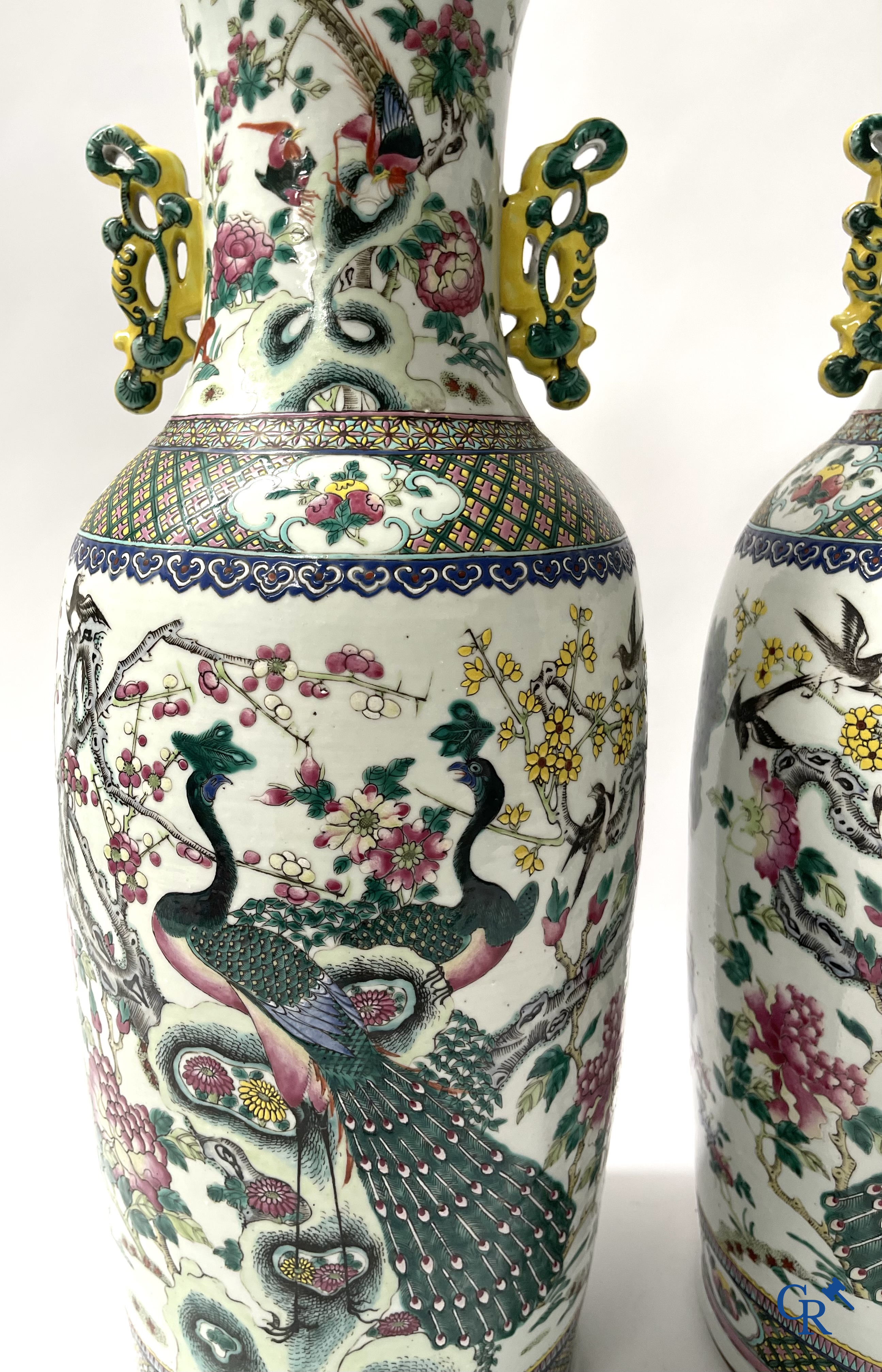 Asian Art, A pair of Chinese famille rose vases with peacocks and Fo dogs. 19th century.